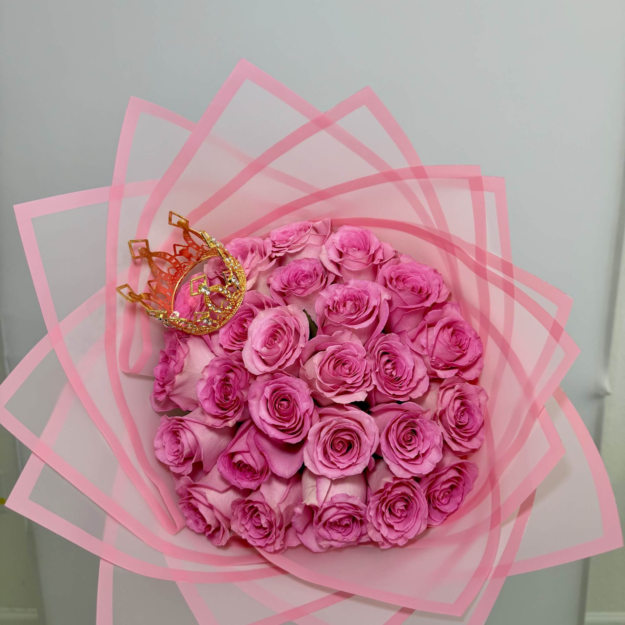 Soft light pink roses wrapped in blush pink paper, topped with a