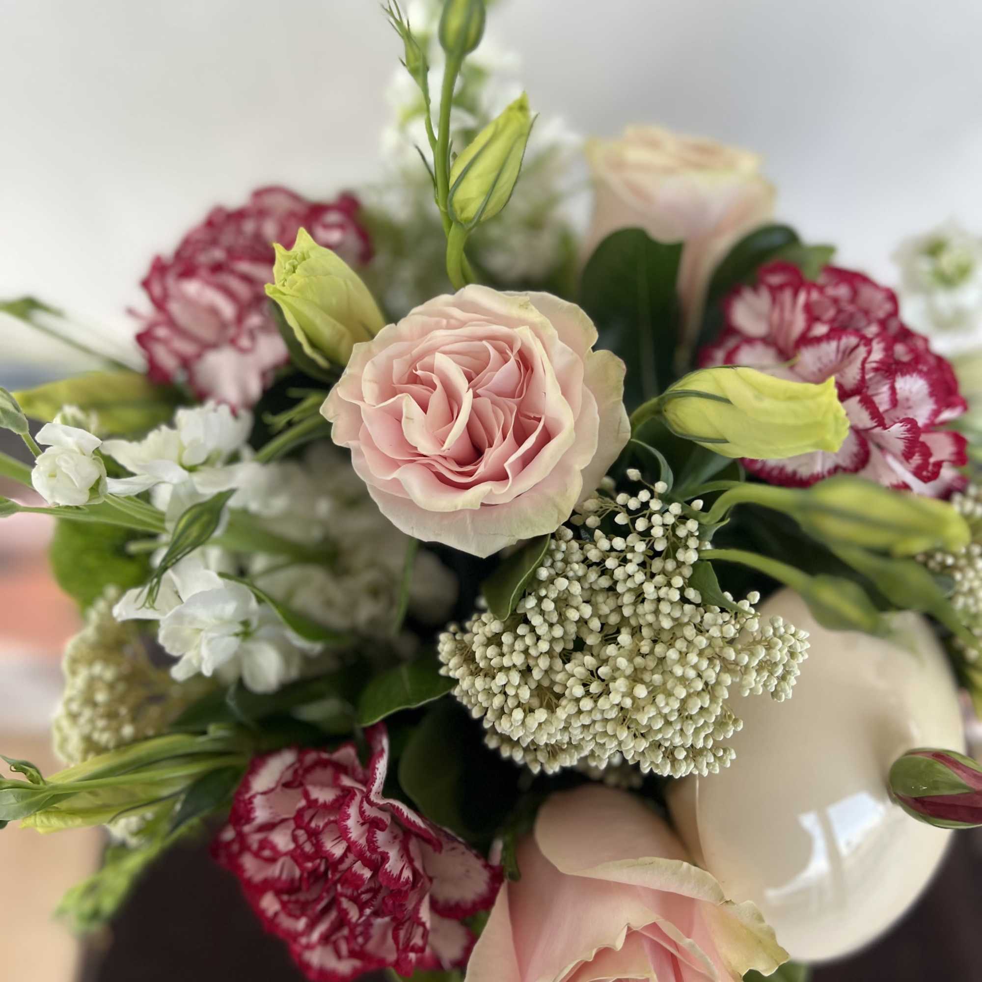 A vintage color palette blooms nestled in a keepsake teapot. 