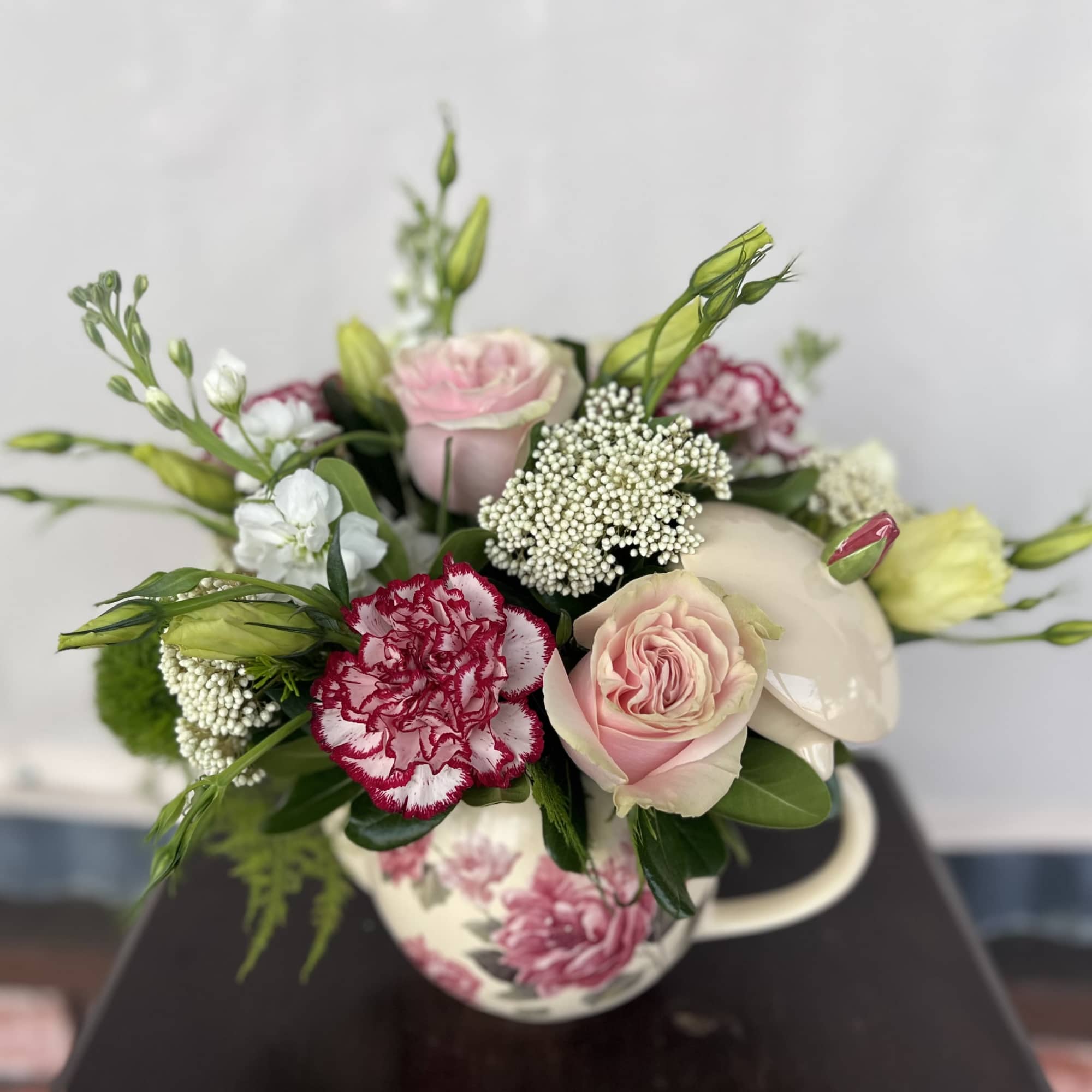 A vintage color palette blooms nestled in a keepsake teapot. 