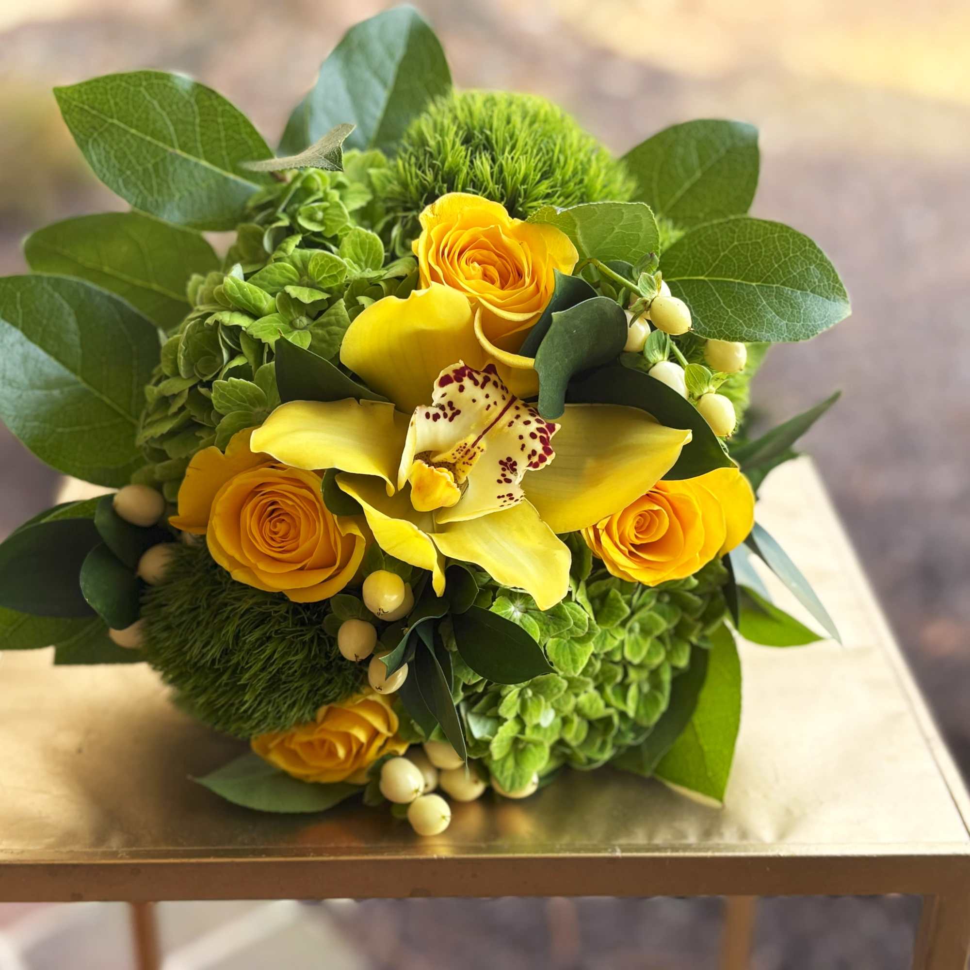 Yellow rose and calla lily bouquet with green hydrangeas and berries