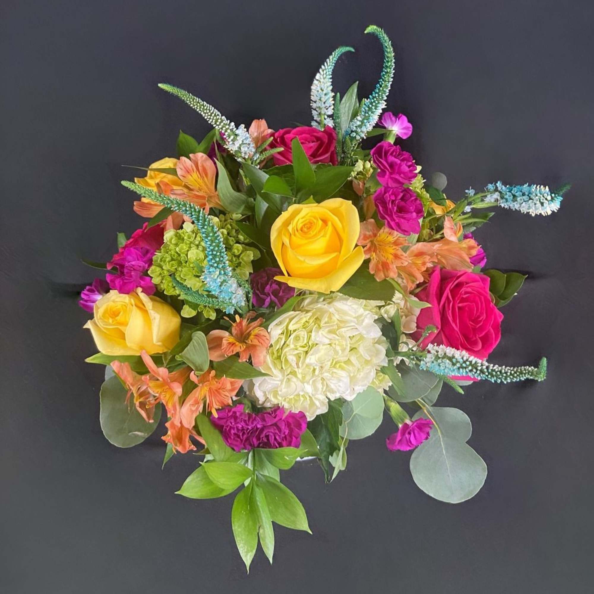 This vibrant arrangement is a cheerful garden party in a cup! It&rsquo;s