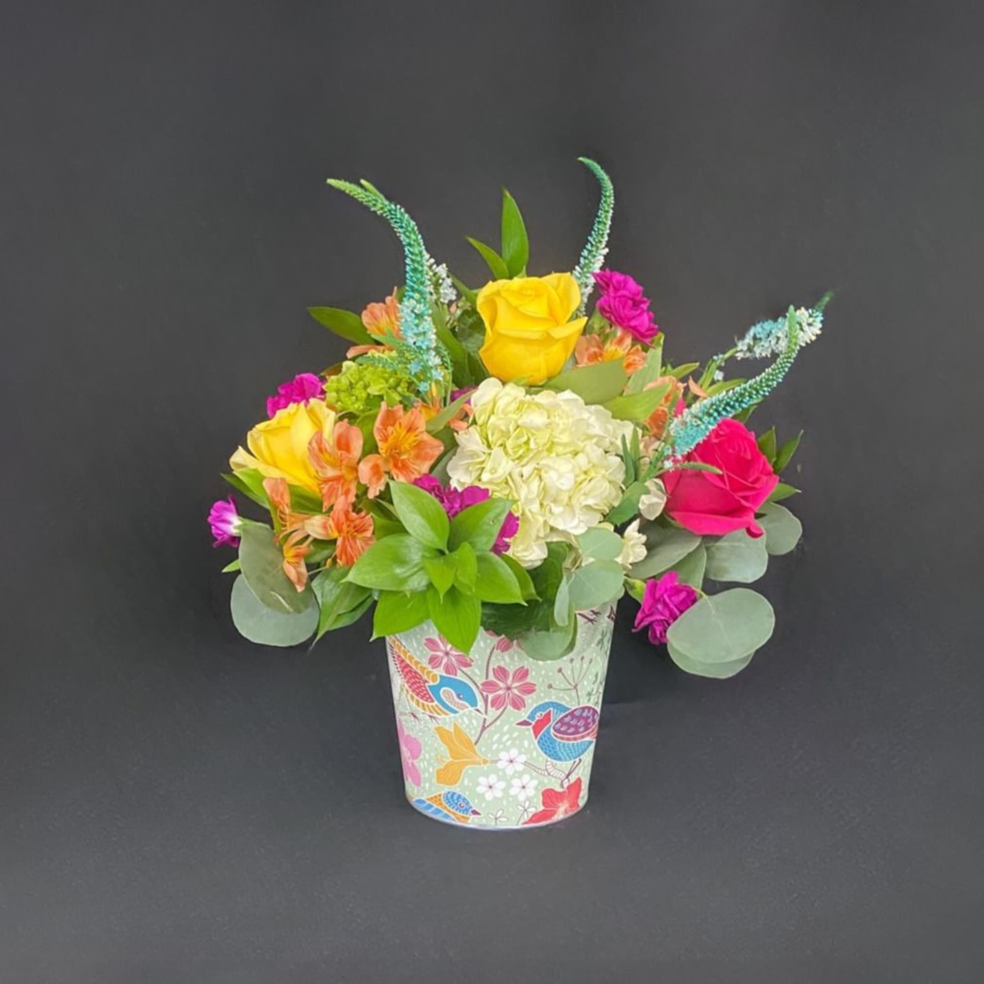 This vibrant arrangement is a cheerful garden party in a cup! It&rsquo;s