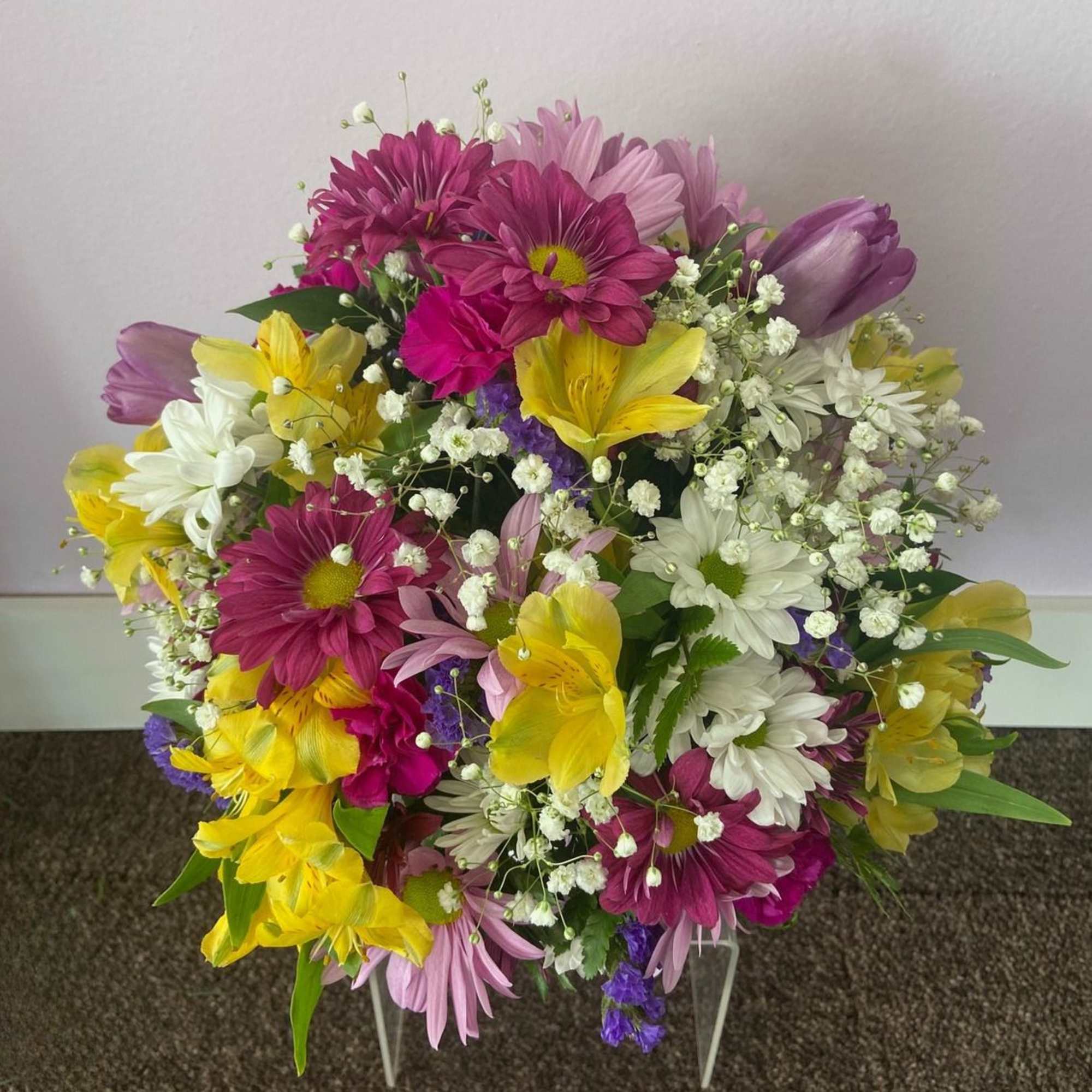 This beautiful pastel pail is full of lovely spring blooms, any mother