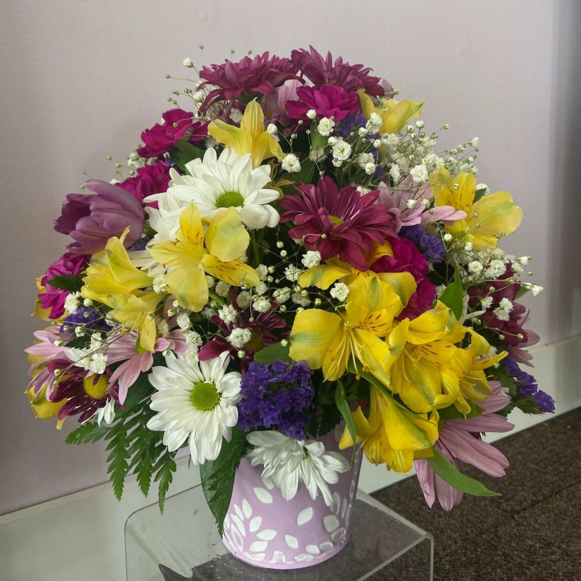 This beautiful pastel pail is full of lovely spring blooms, any mother