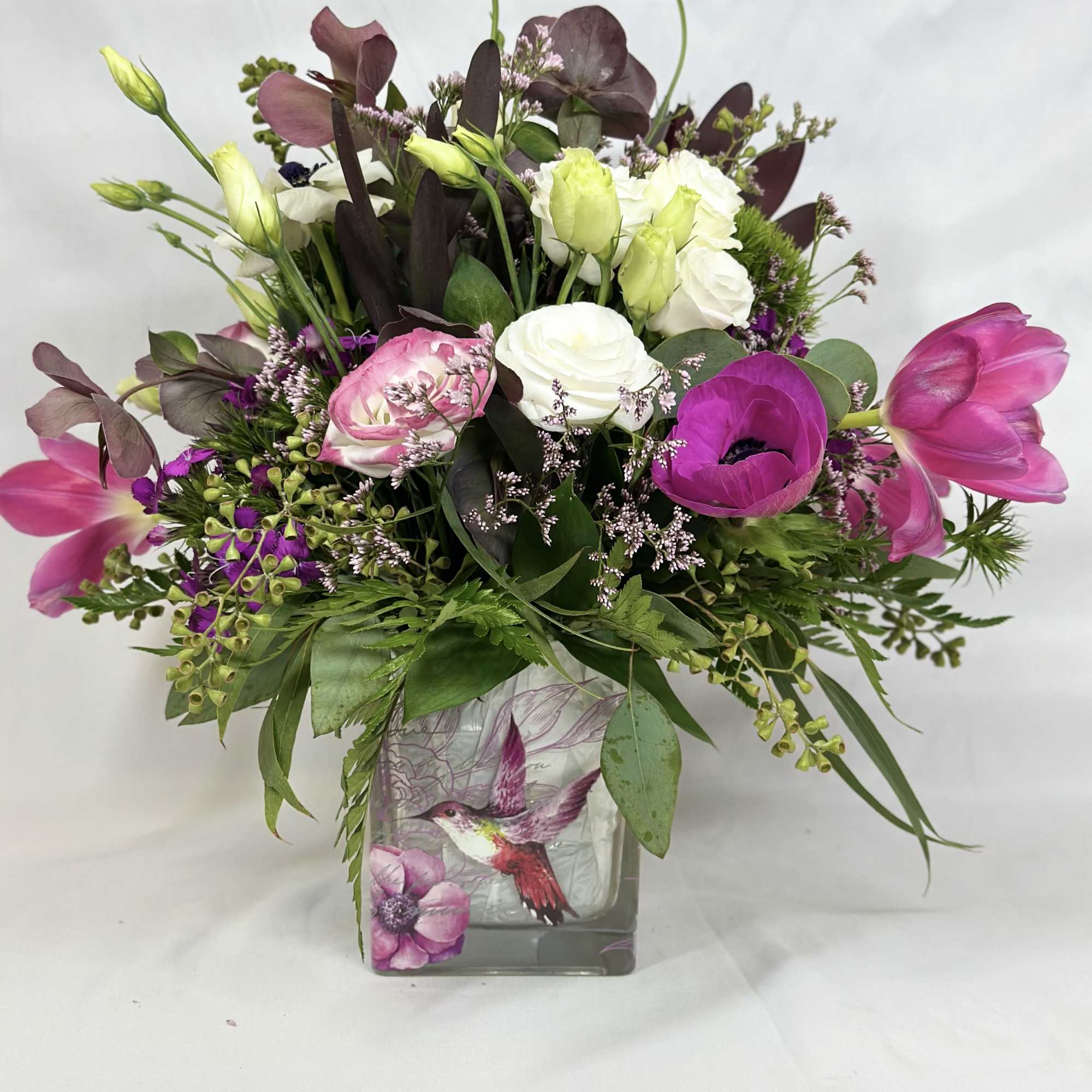 This delightful design features a large array of beautiful flowers in a