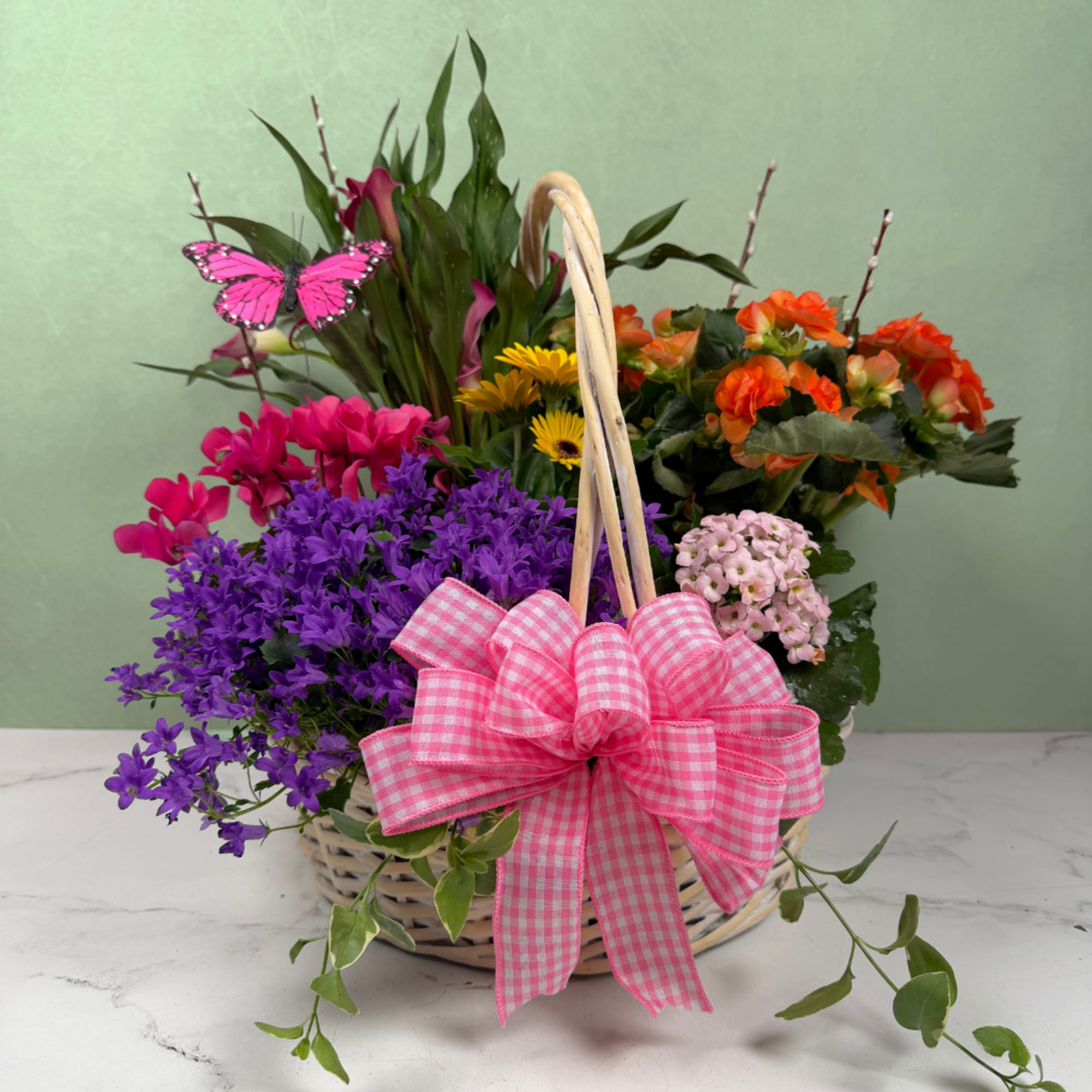 A cheerful woven basket overflowing with bright springtime color, this garden in