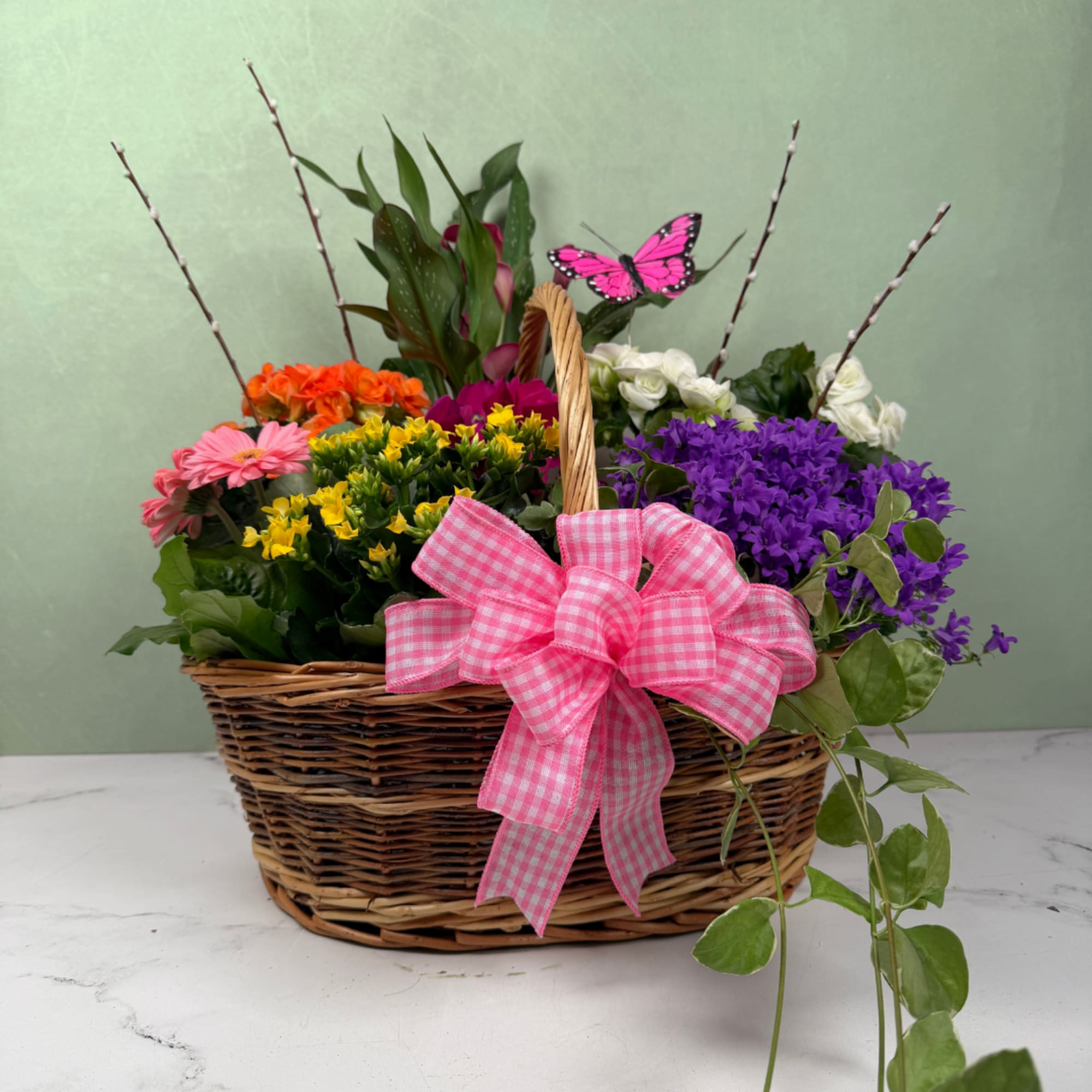 A cheerful woven basket overflowing with bright springtime color, this garden in