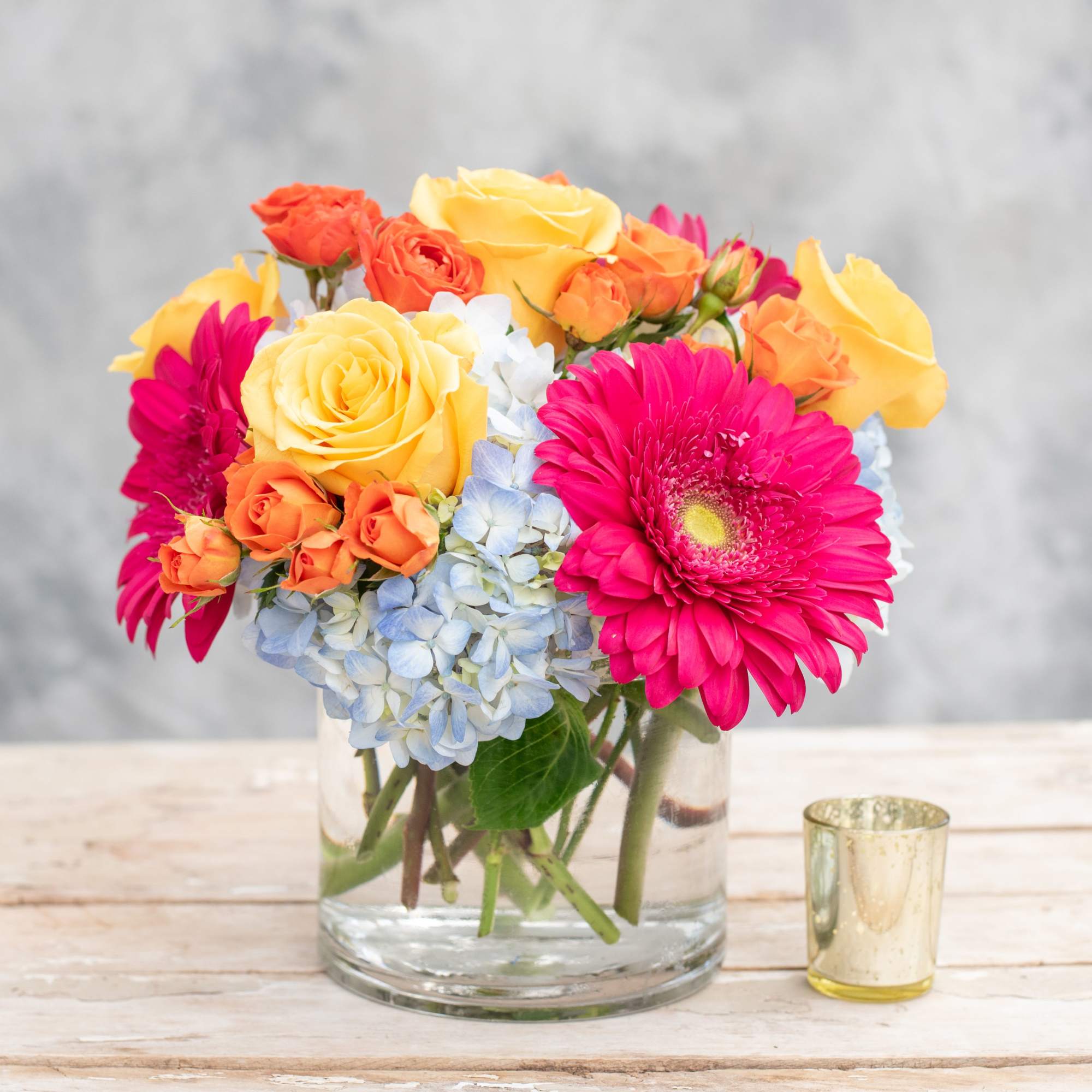 This beautiful arrangement is sure to brighten up any table or corner.