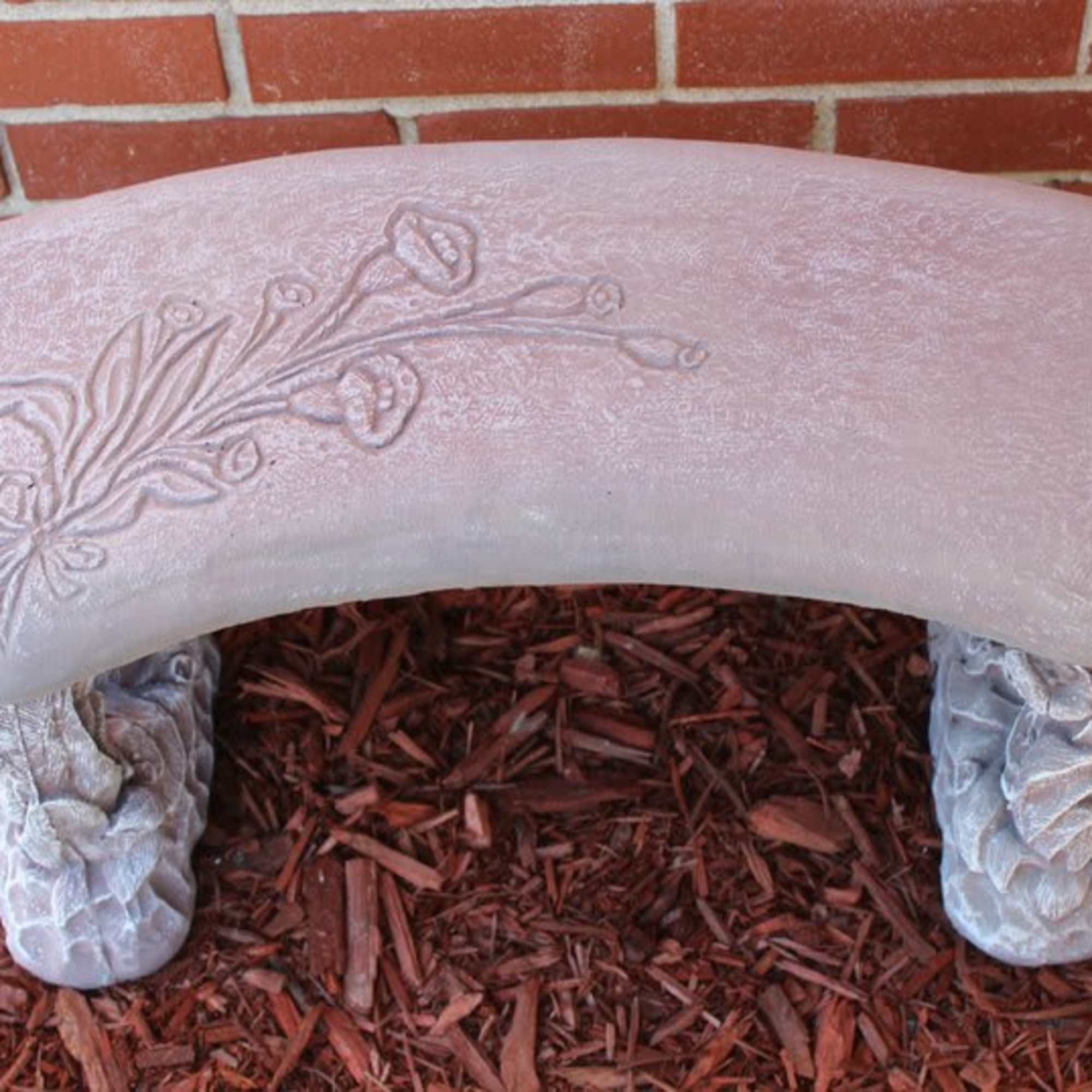 Decorative stone bench with a floral relief pattern