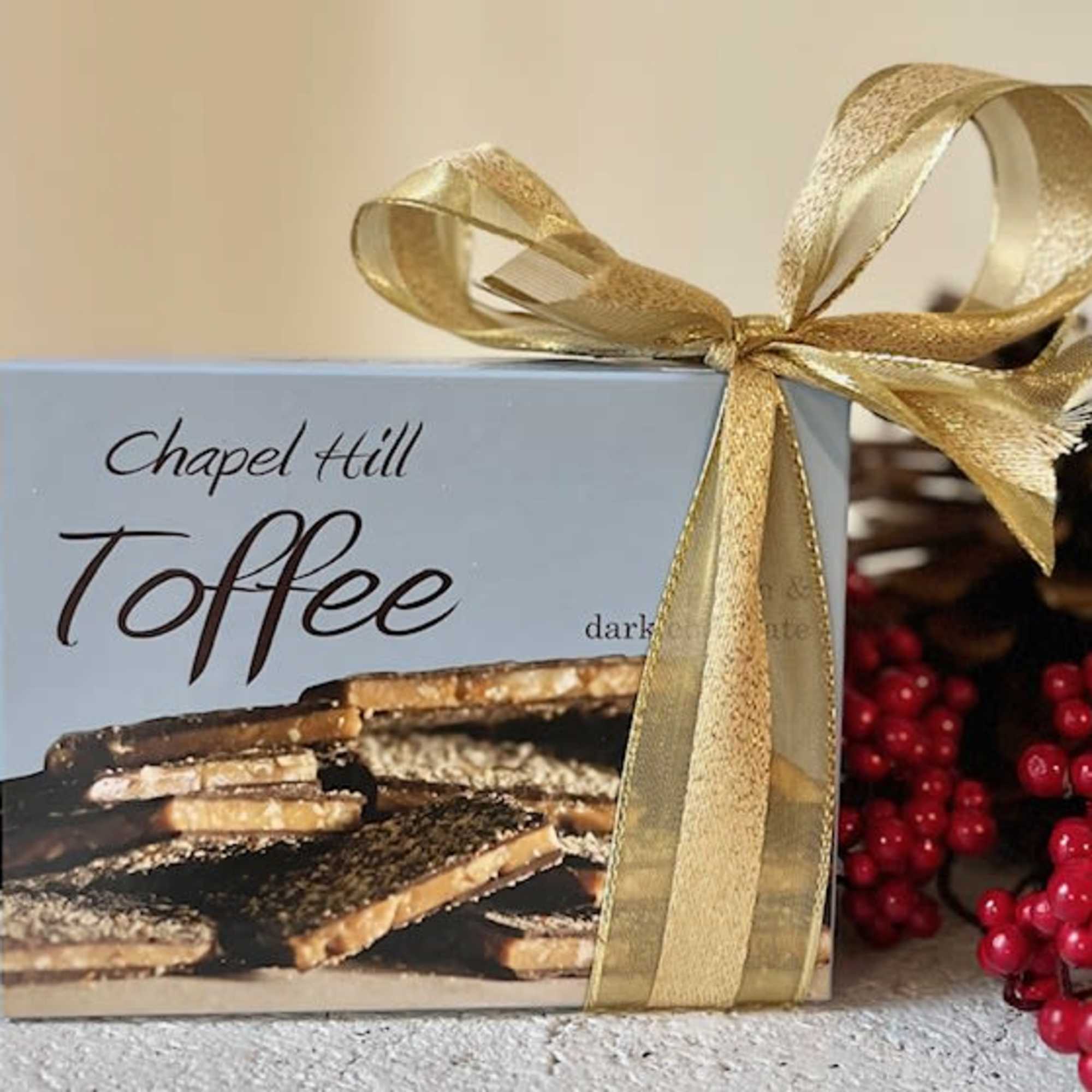 Box of Chapel Hill Toffee tied with a gold ribbon
