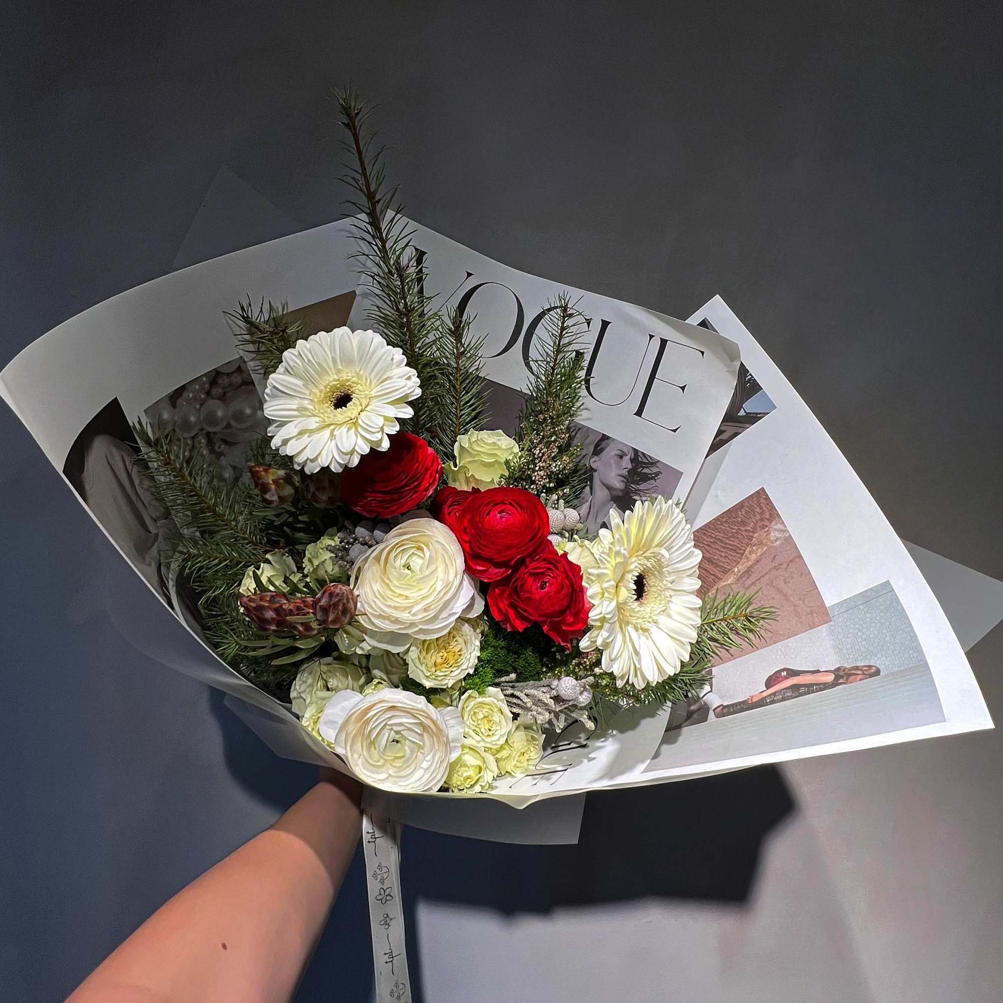Bouquet of red and white flowers wrapped in paper