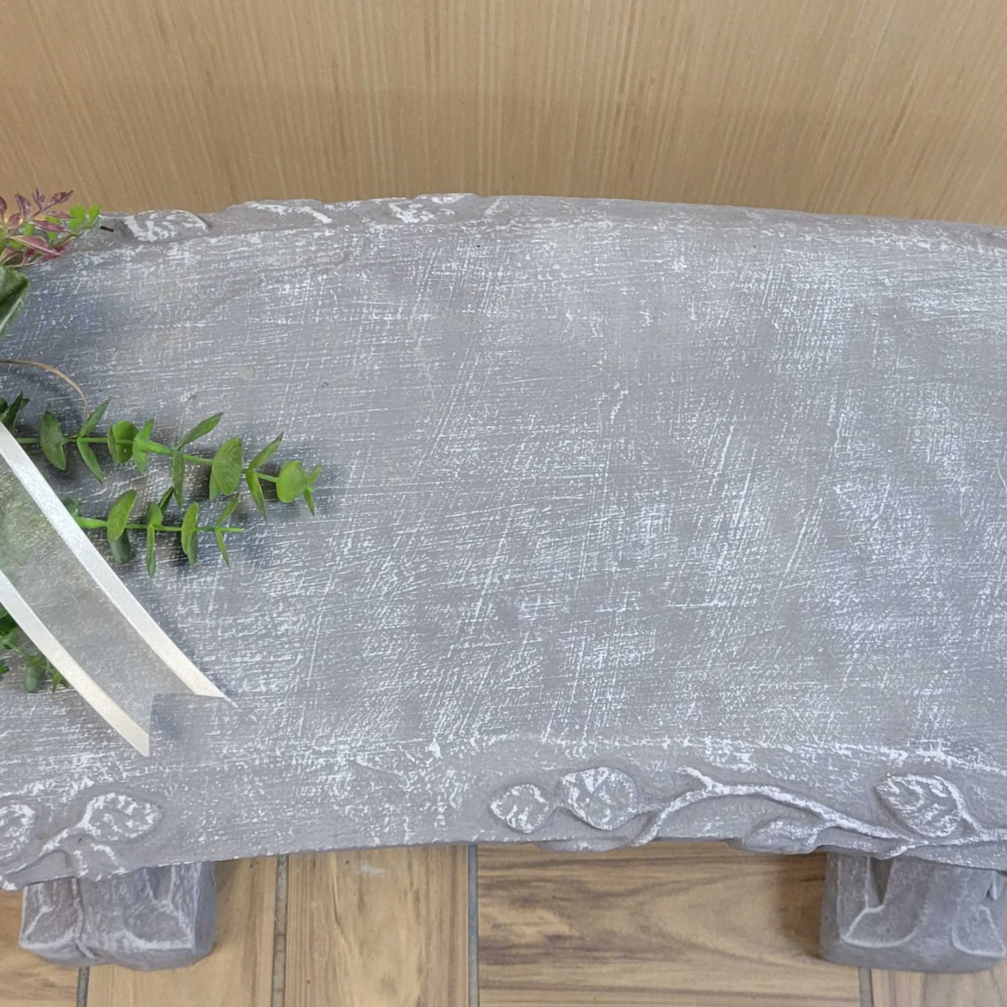 White floral spray with ribbon on a gray casket