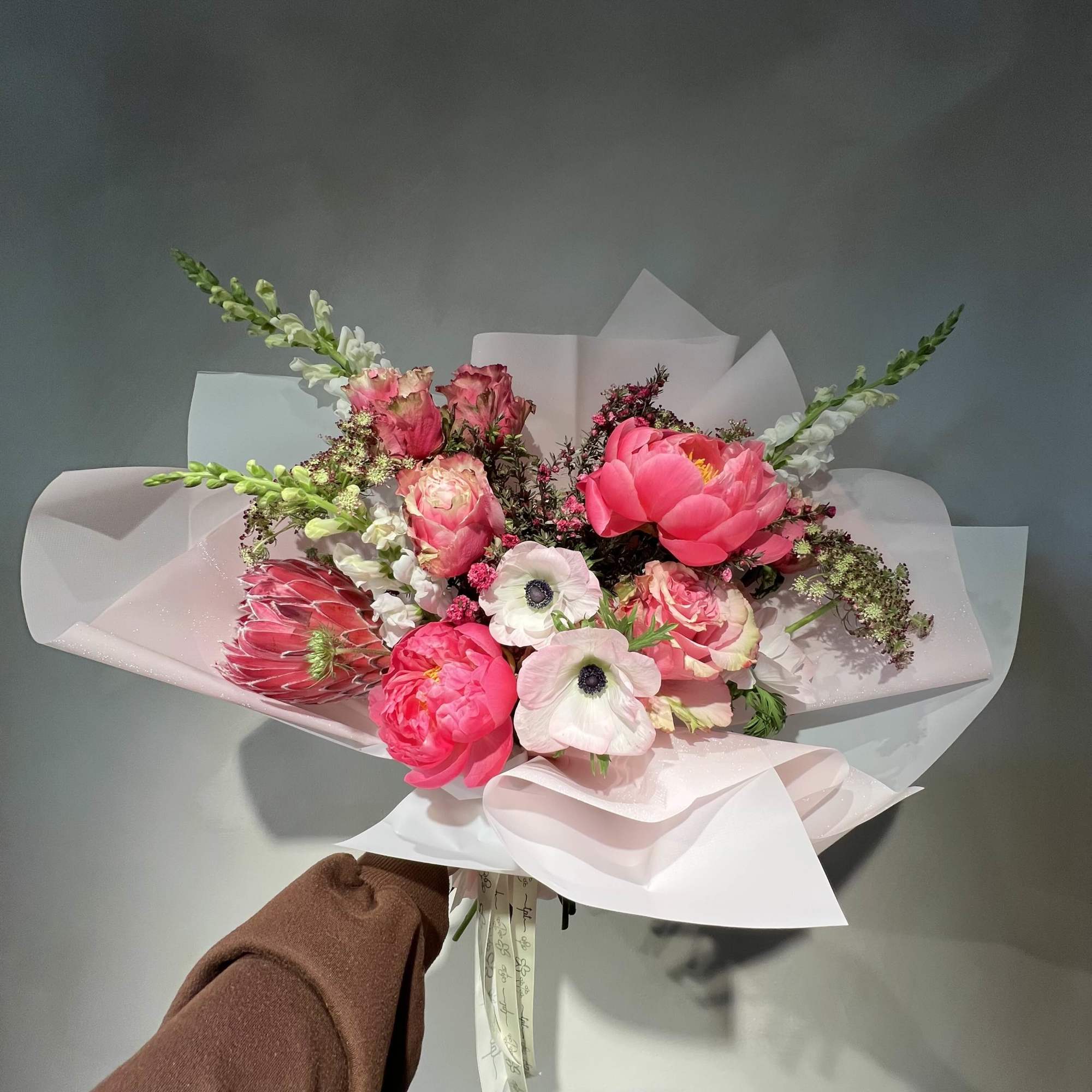 A soft, all-pink bouquet composed in layered tones - bringing together seasonal