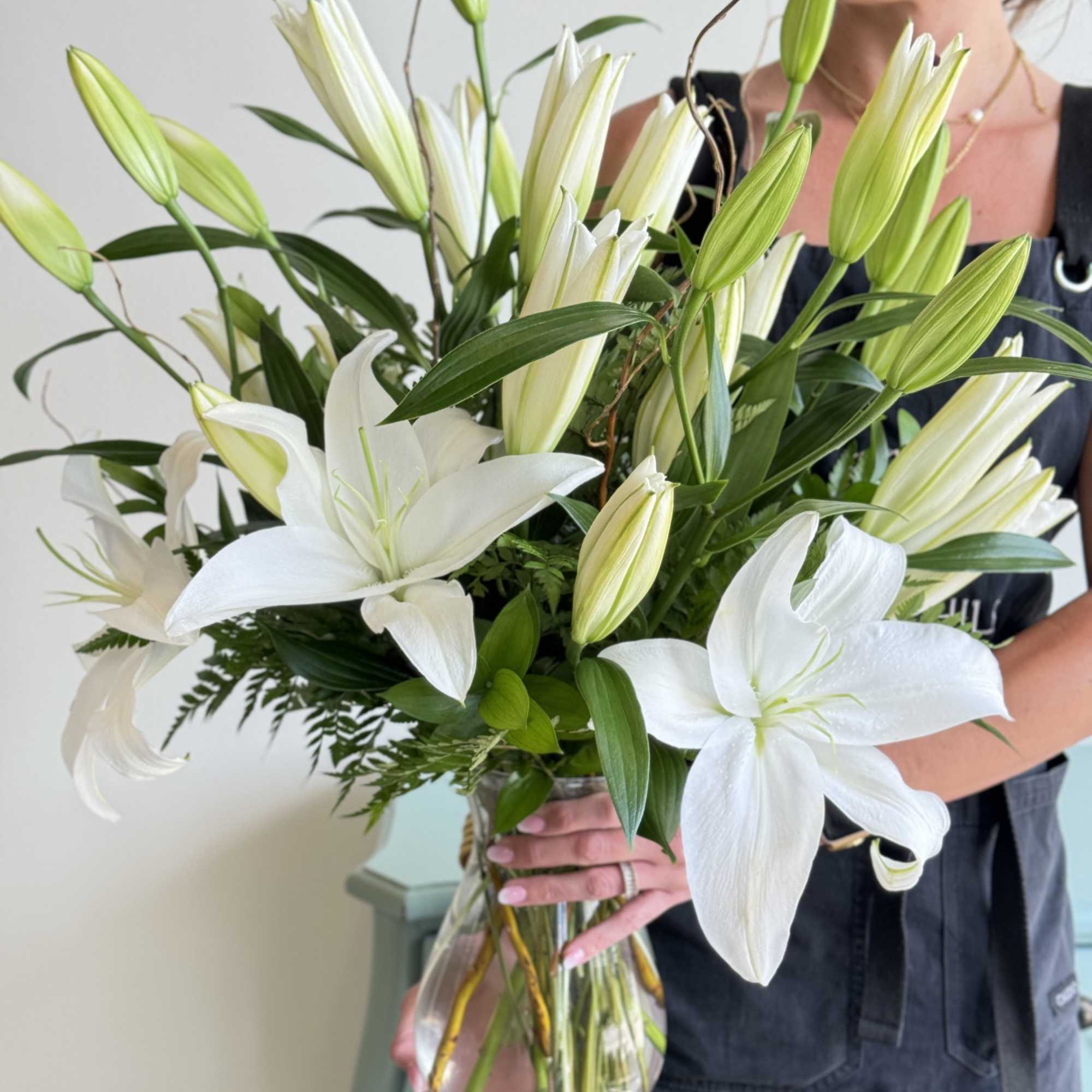Bouquet of white lilies in a clear glass vase