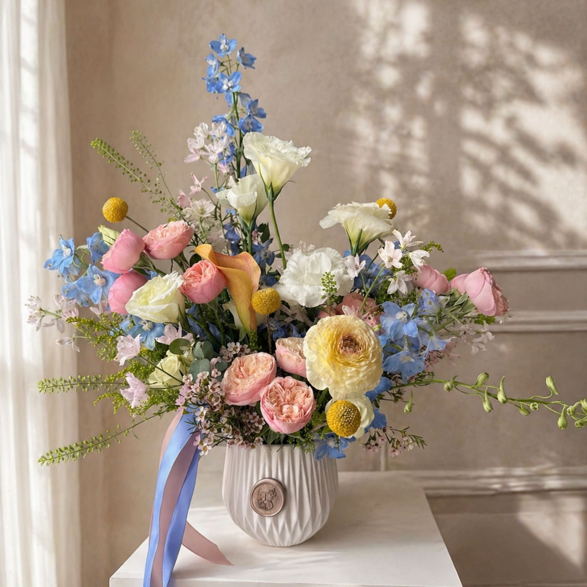 This arrangement features a unique mix of fresh flowers, varying each week