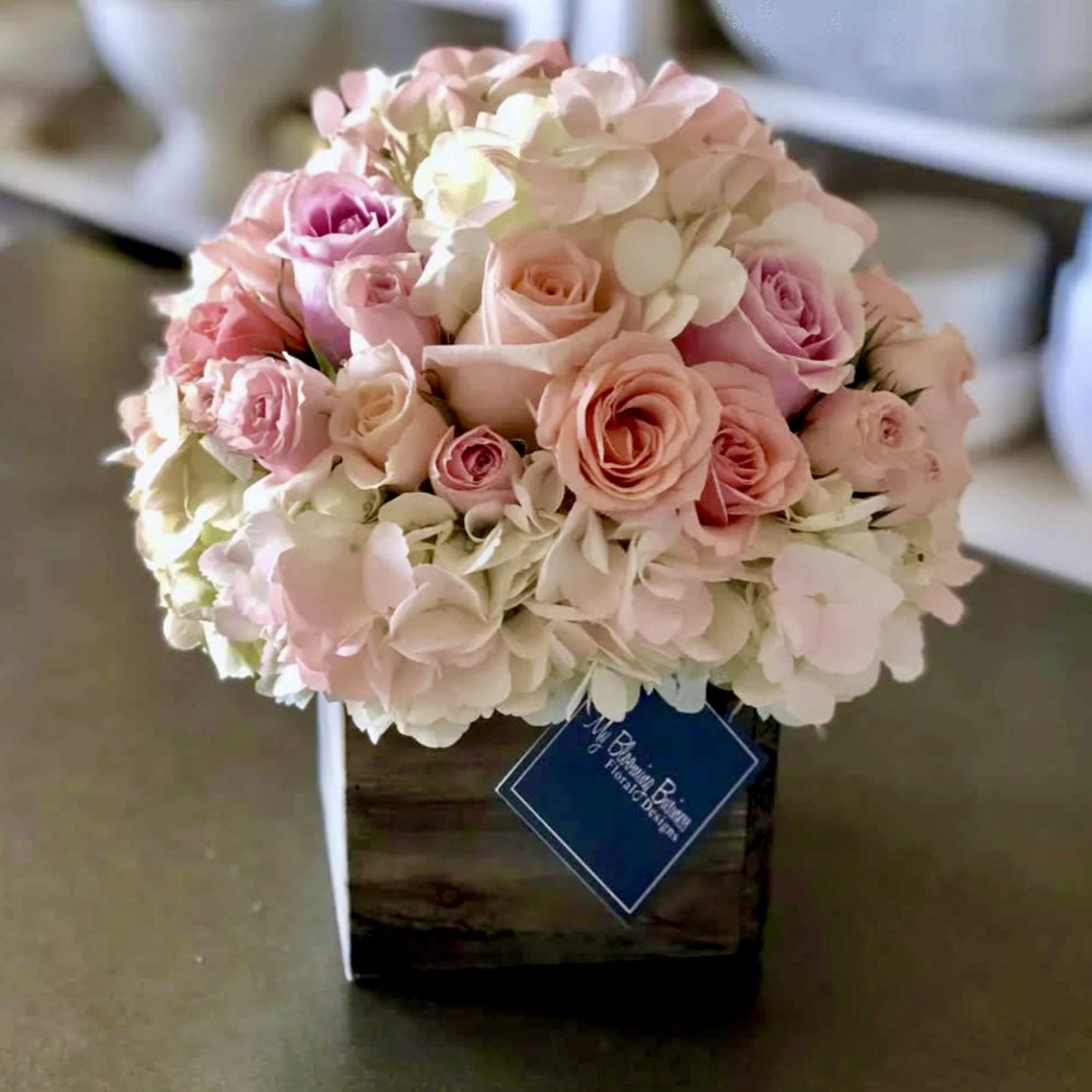 Pink and white rose bouquet in a wooden box