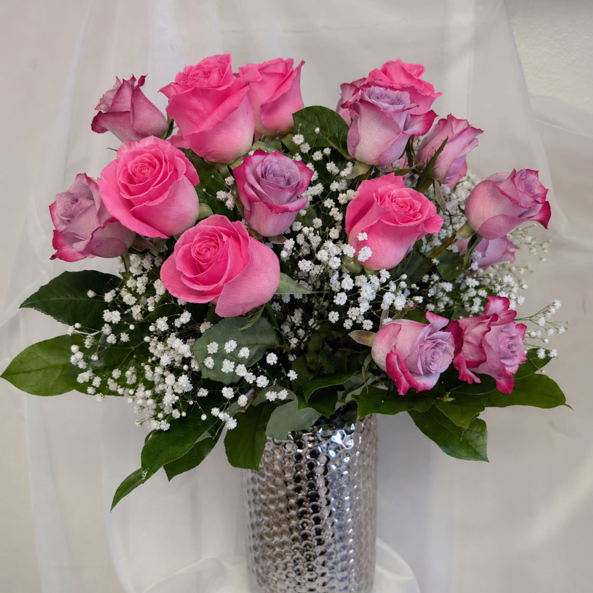 12 deep purple roses, and 12 sweet unique roses surrounded by baby's