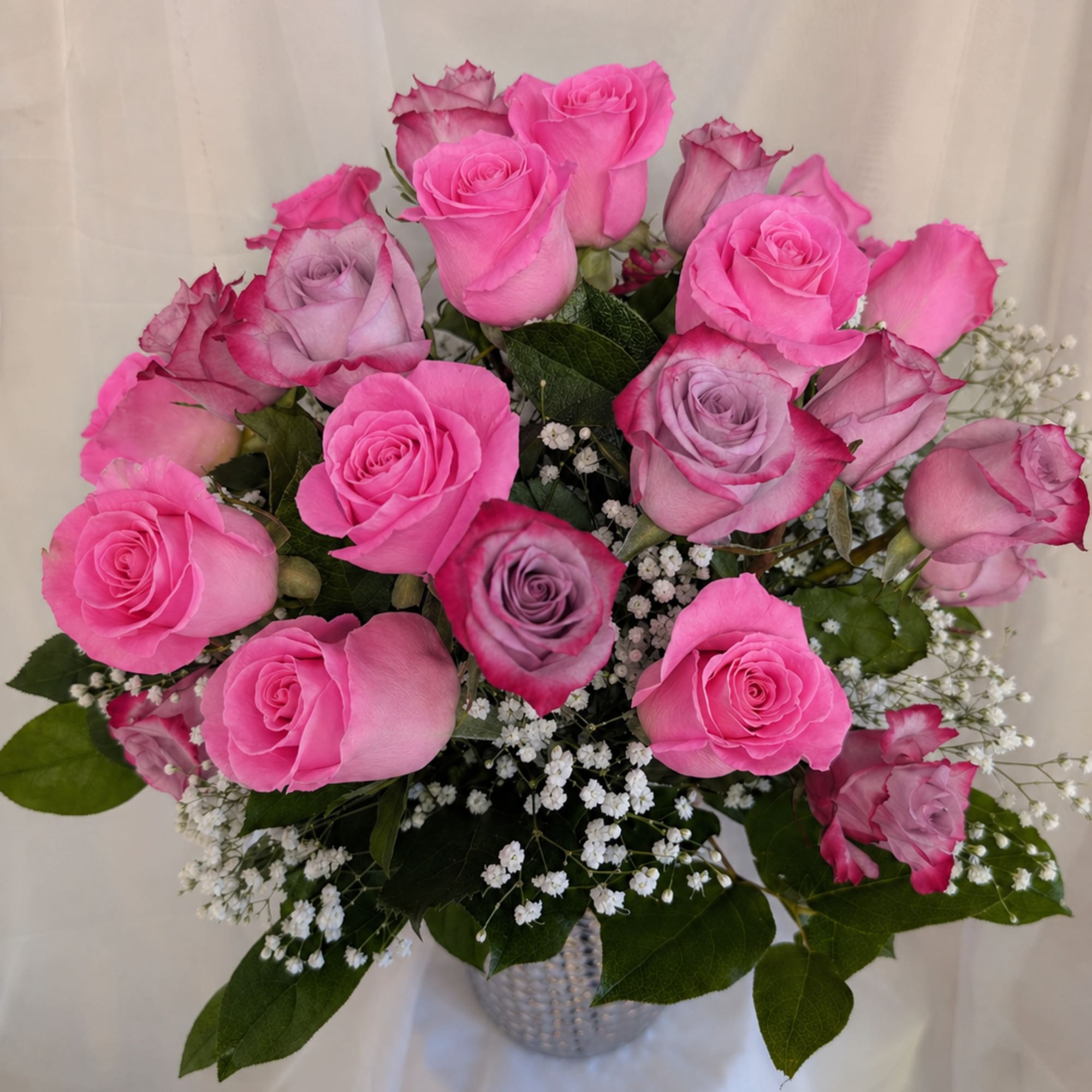12 deep purple roses, and 12 sweet unique roses surrounded by baby's