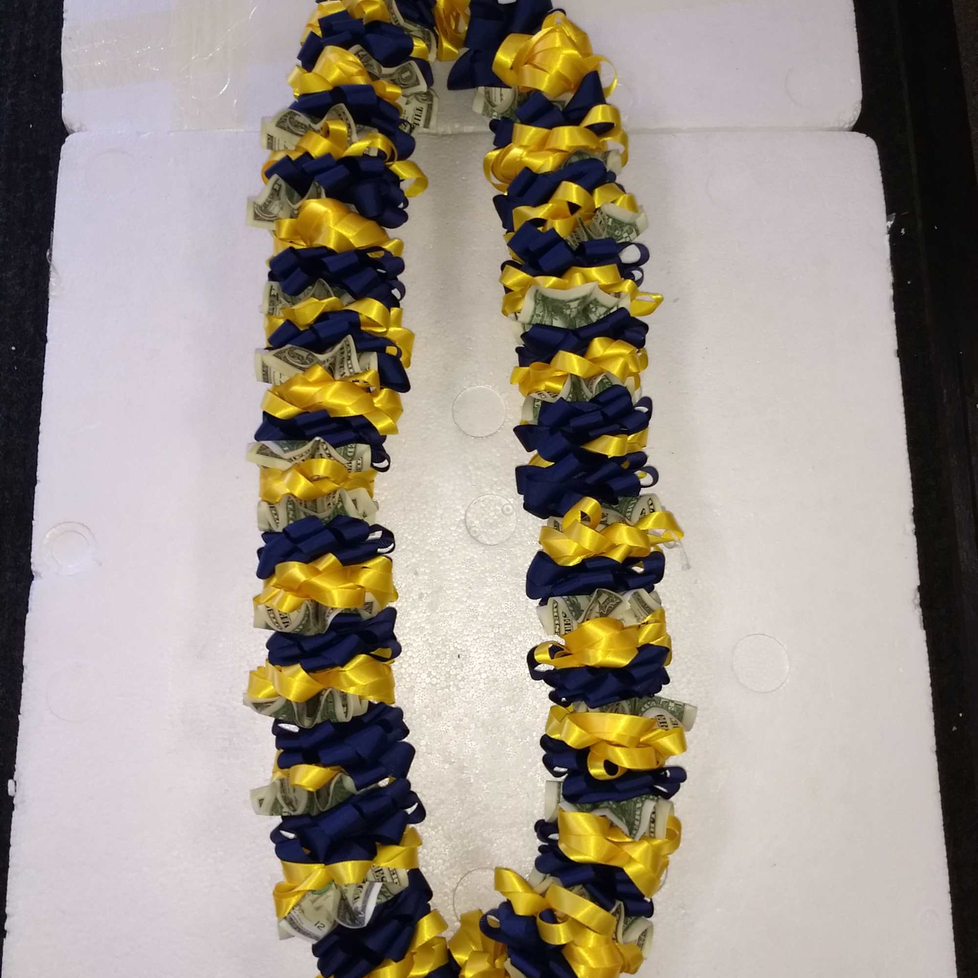 (25) $1 bill attached to fabric lei
Actual cash bills that are on