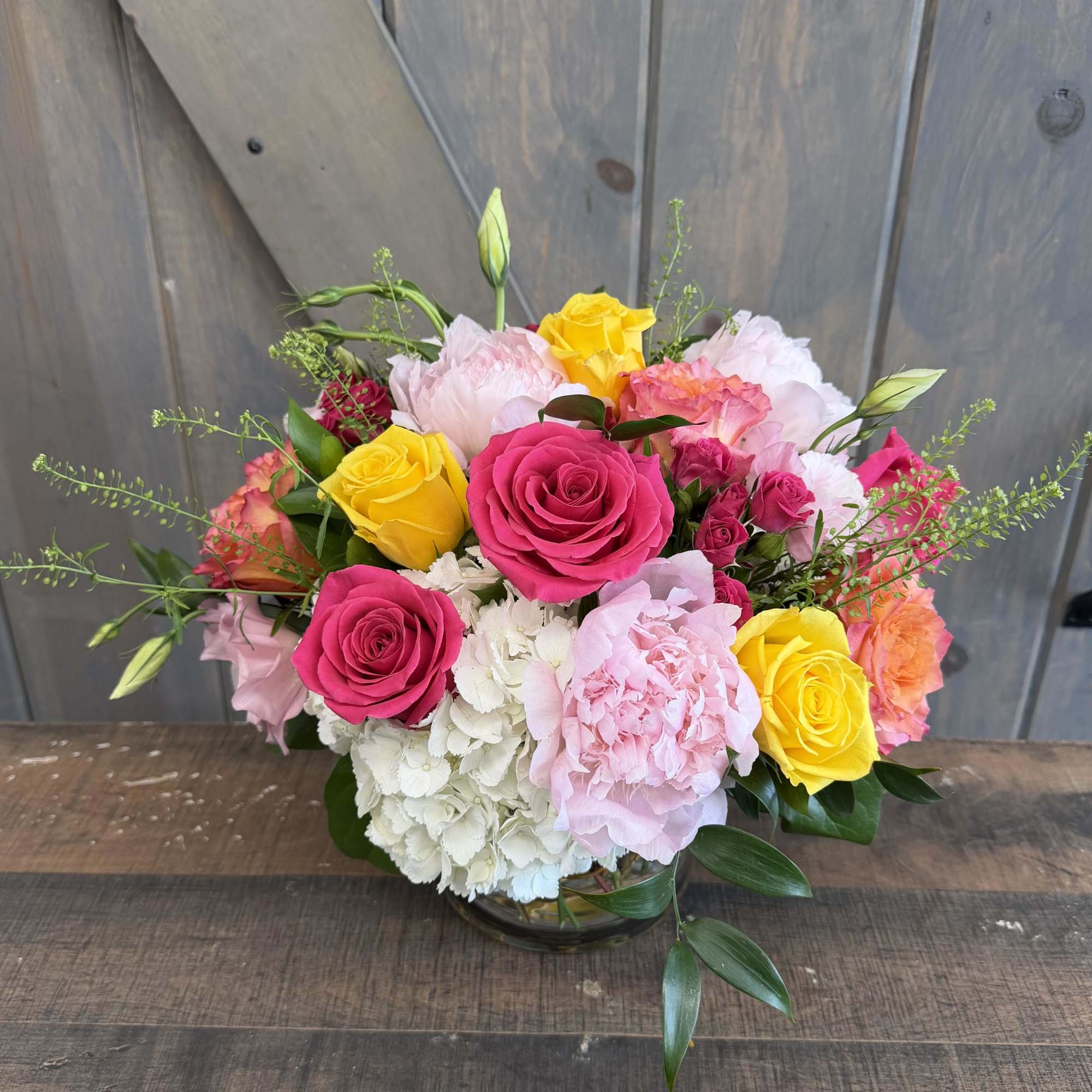 Malaga Sunset is a vibrant garden-style arrangement inspired by golden coastal evenings