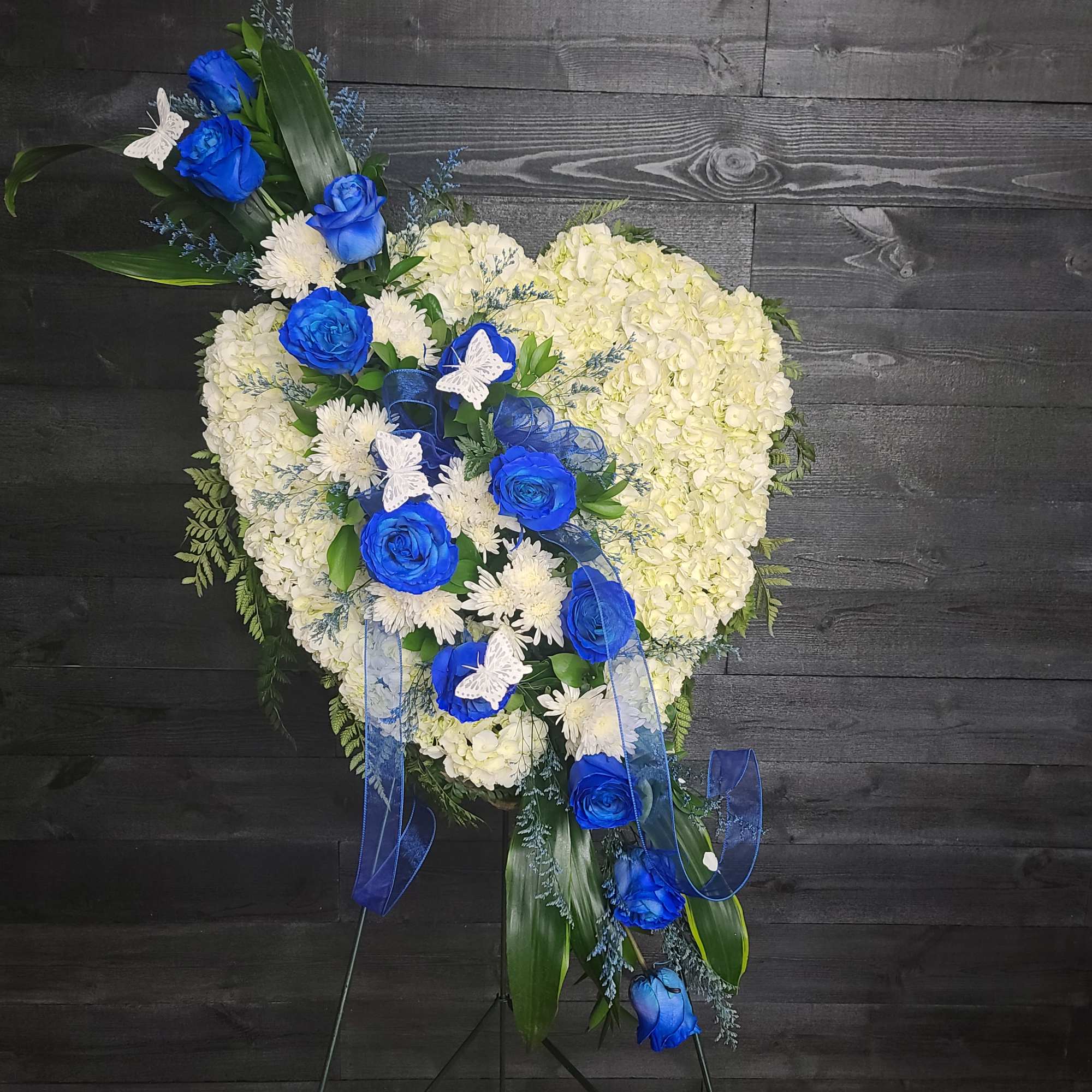 Closed heart full of white and blue flowers.  The white will