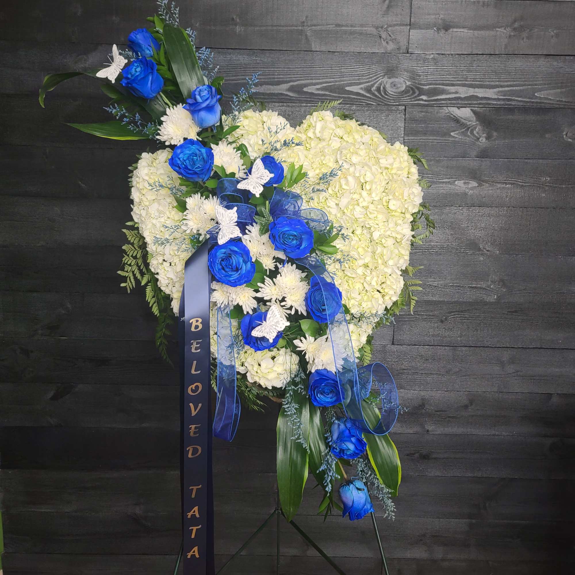Closed heart full of white and blue flowers.  The white will