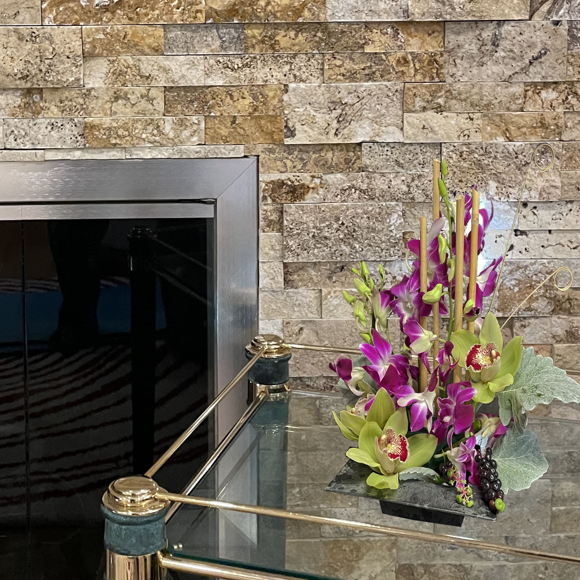 Tall orchid arrangement with green cymbidium blooms and purple dendrobiums