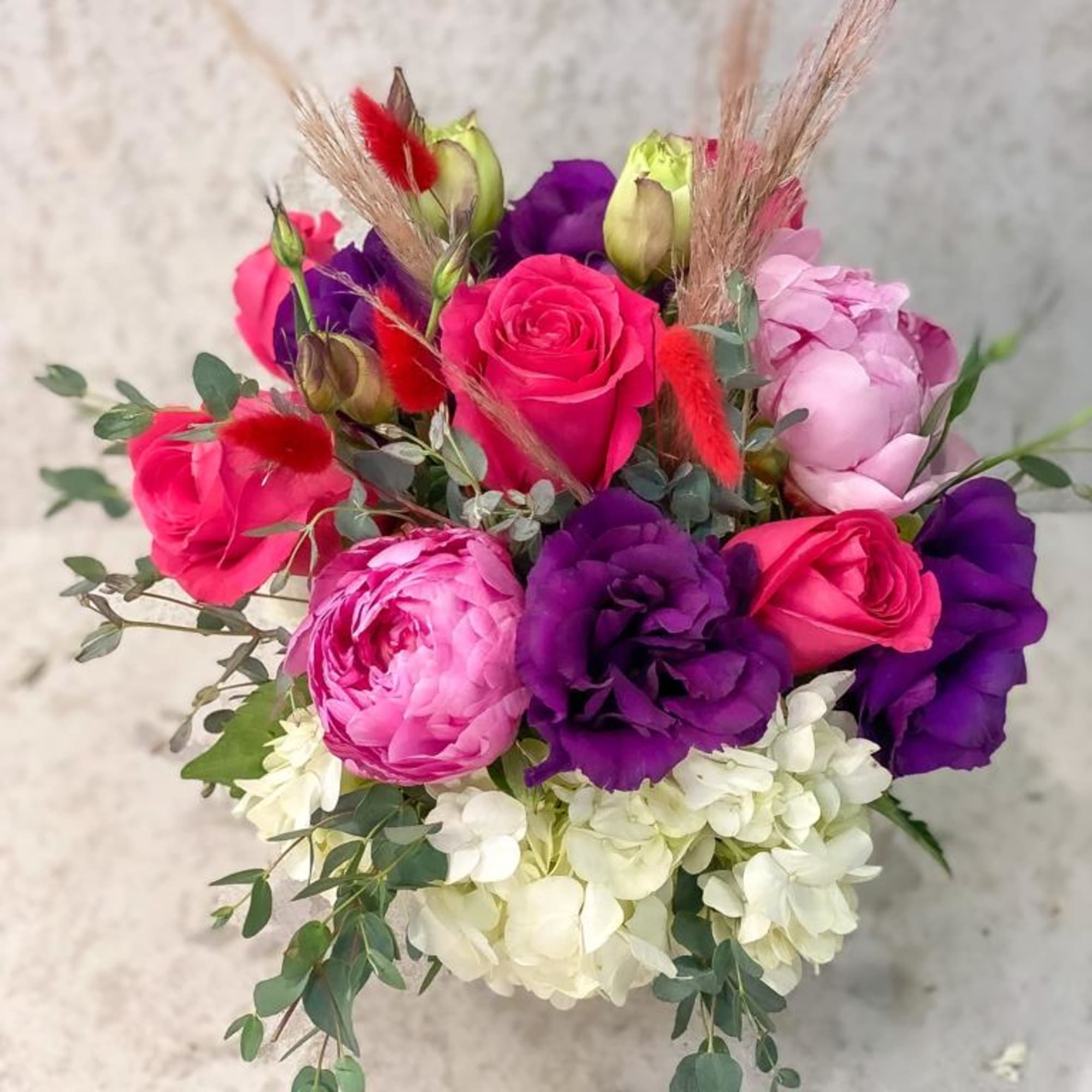Bouquet of pink and purple roses with white hydrangea