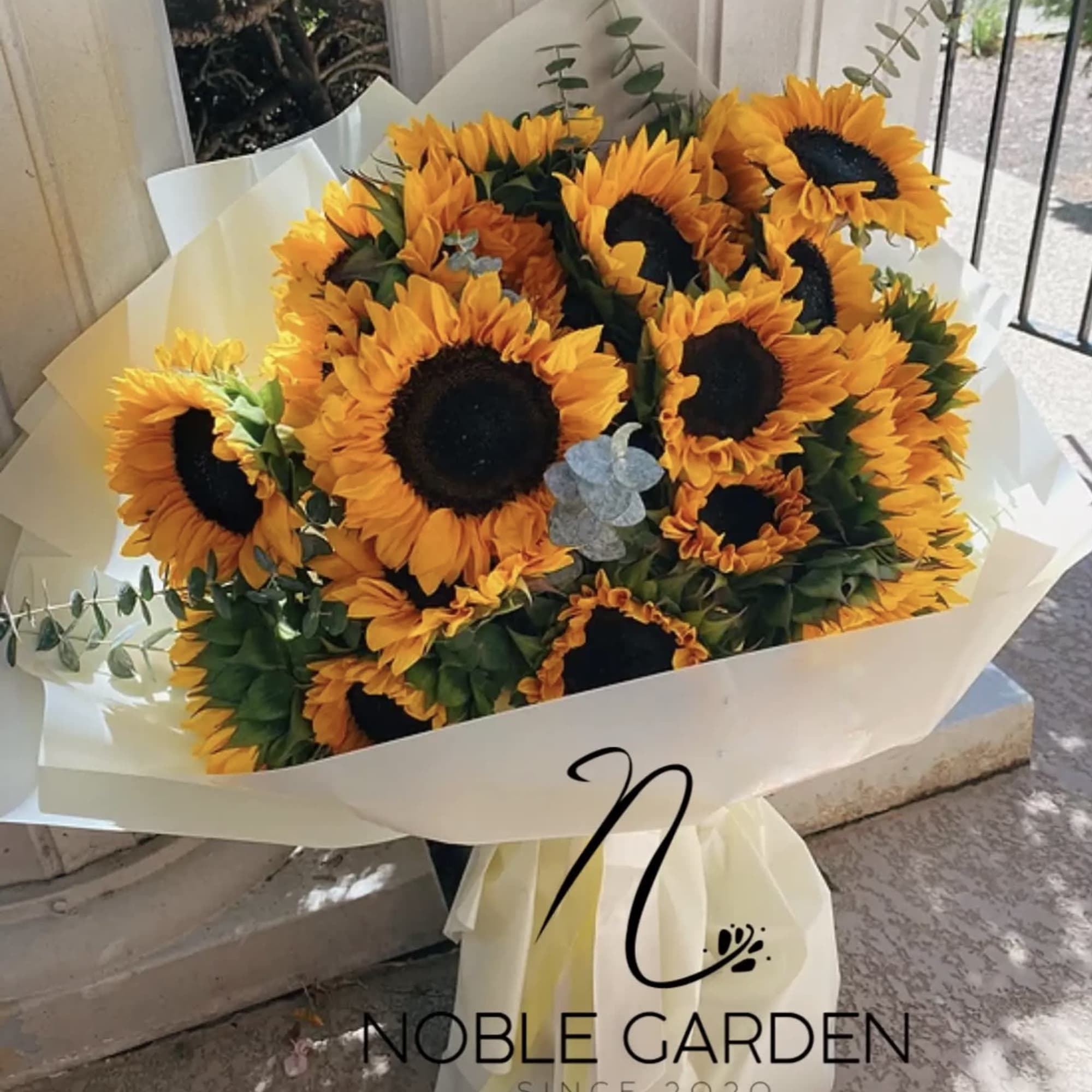 Bouquet of sunflowers wrapped in white paper