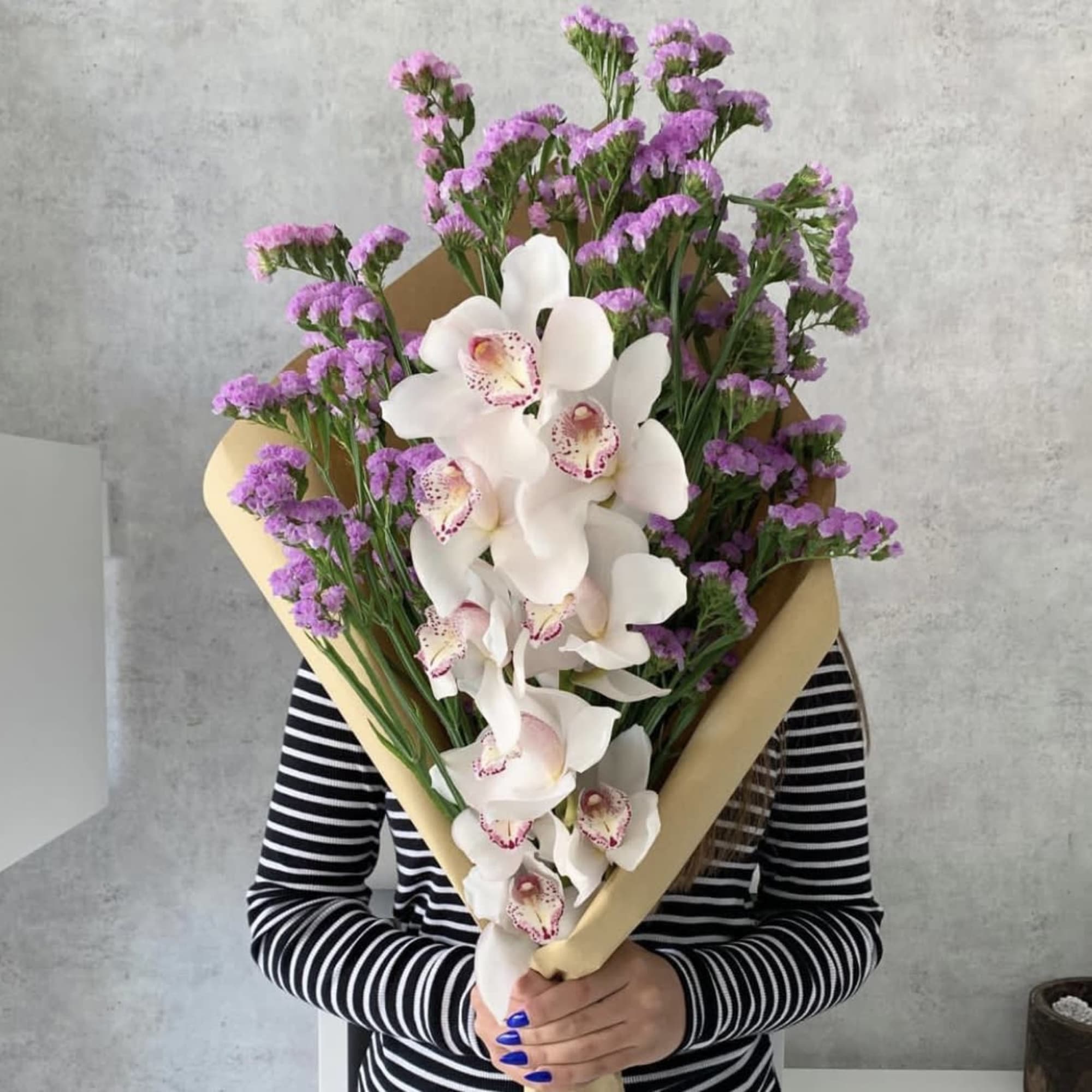 Large bouquet of white orchids and purple filler flowers
