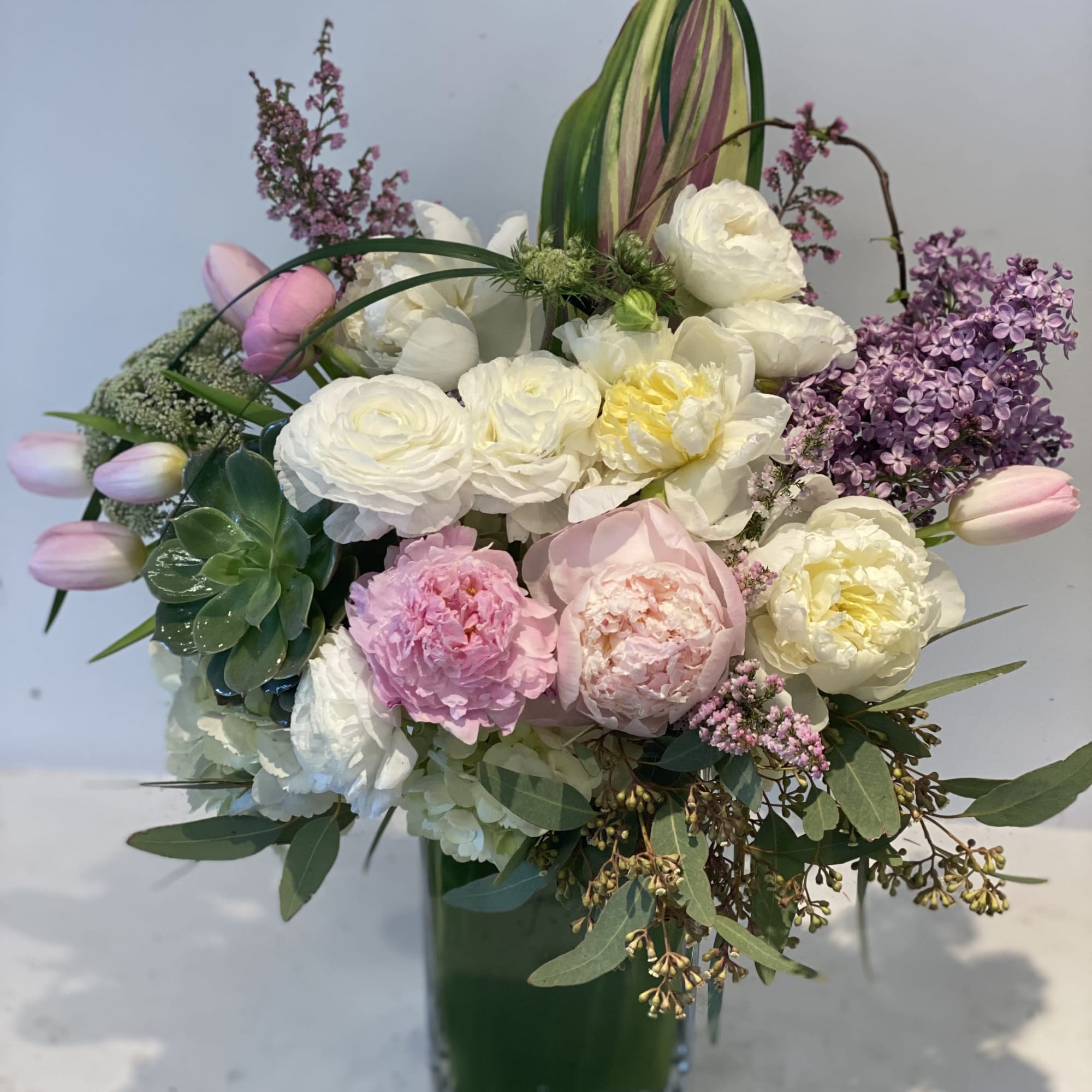 Pink and white mixed bouquet in a tall glass vase