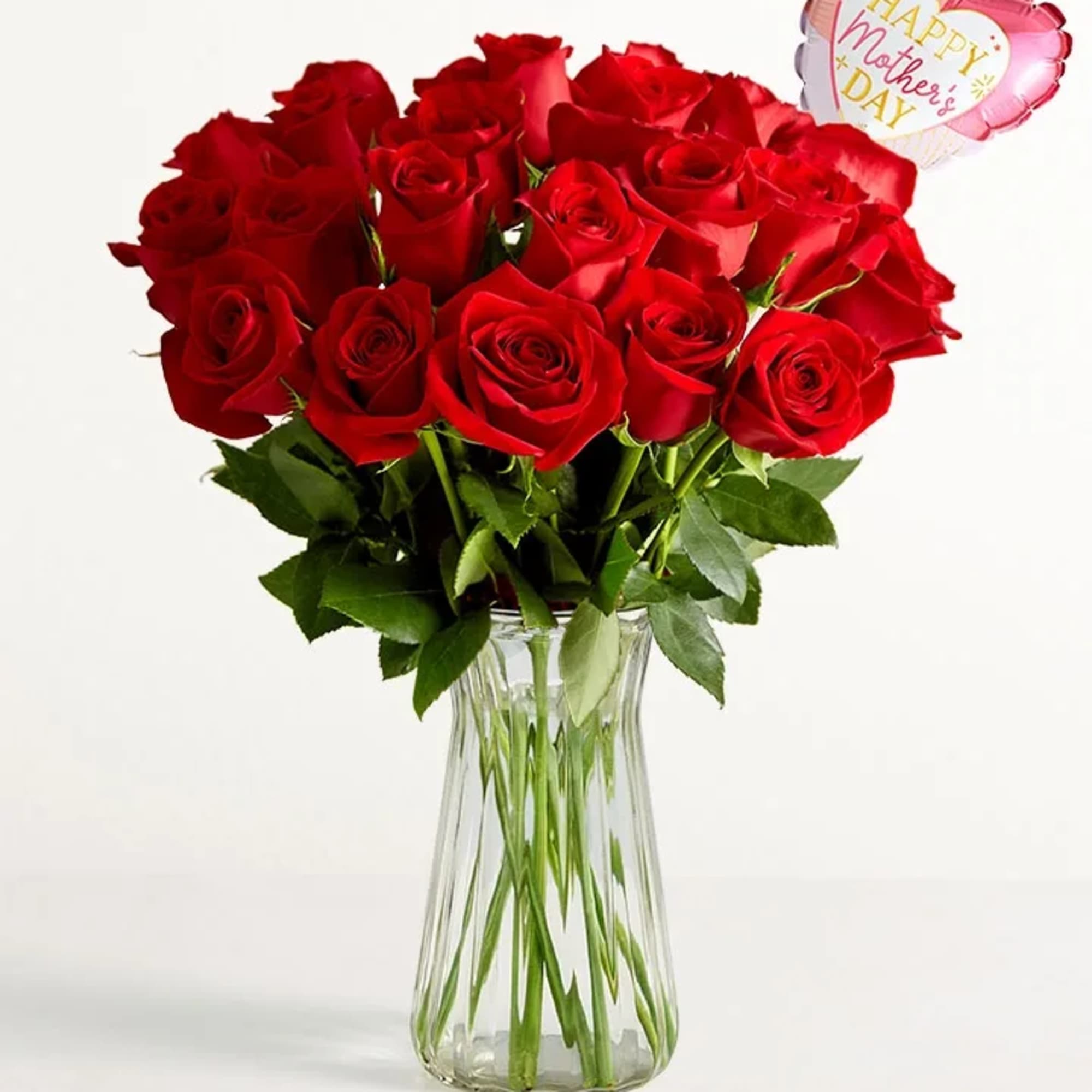 A full, rounded bouquet of deep red roses set in a clear