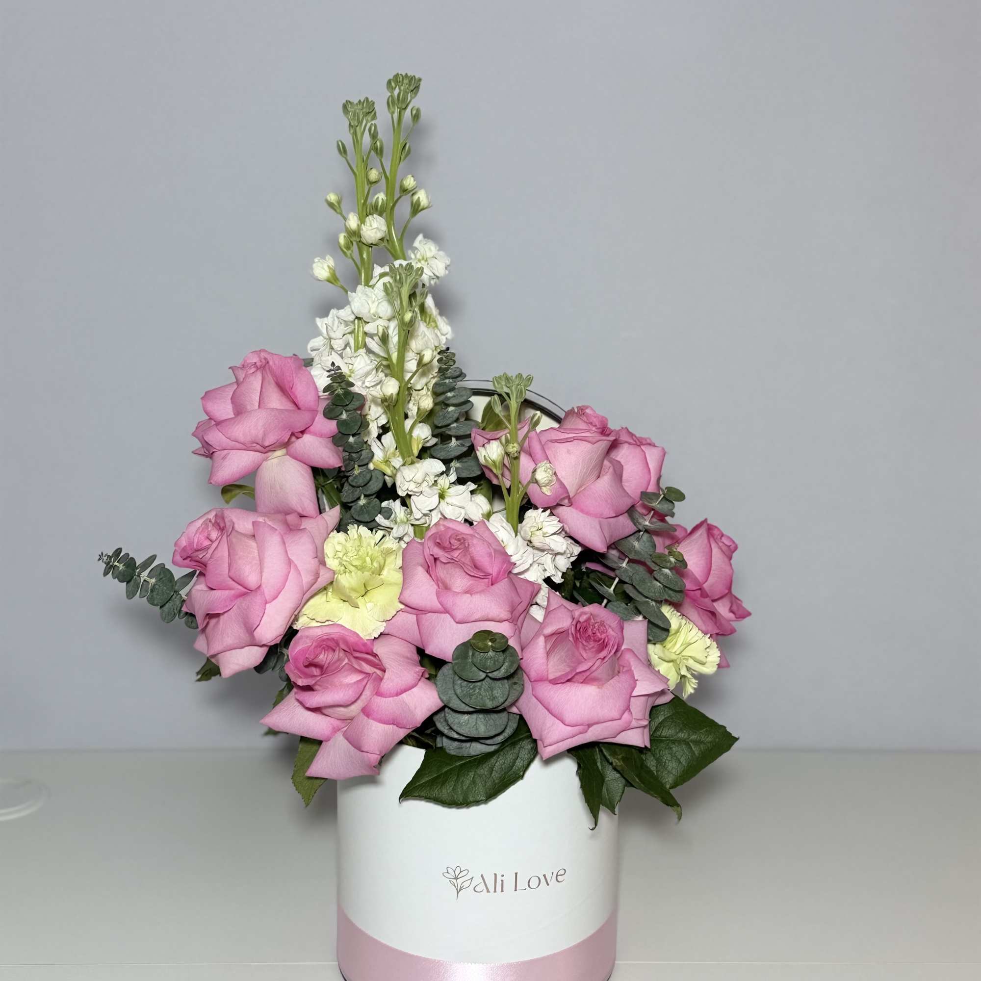 A delicate and elegant bouquet of soft pink roses and stock flowers..