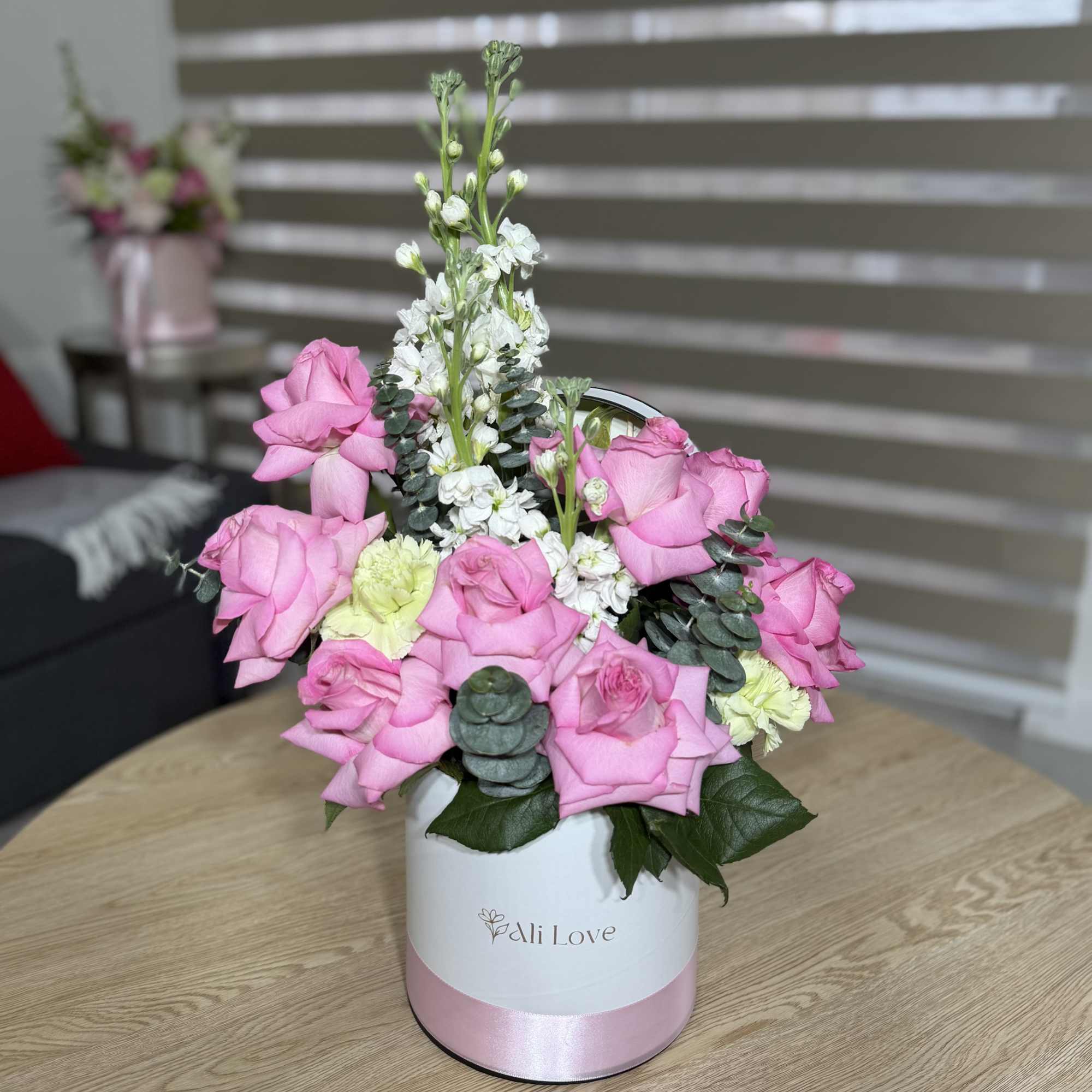 A delicate and elegant bouquet of soft pink roses and stock flowers..