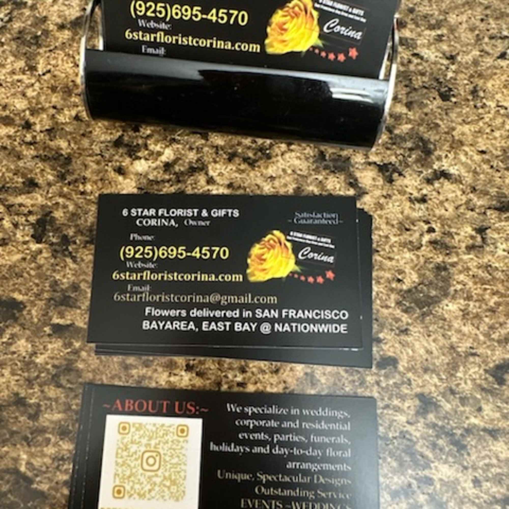 Stack of florist business cards on a granite countertop