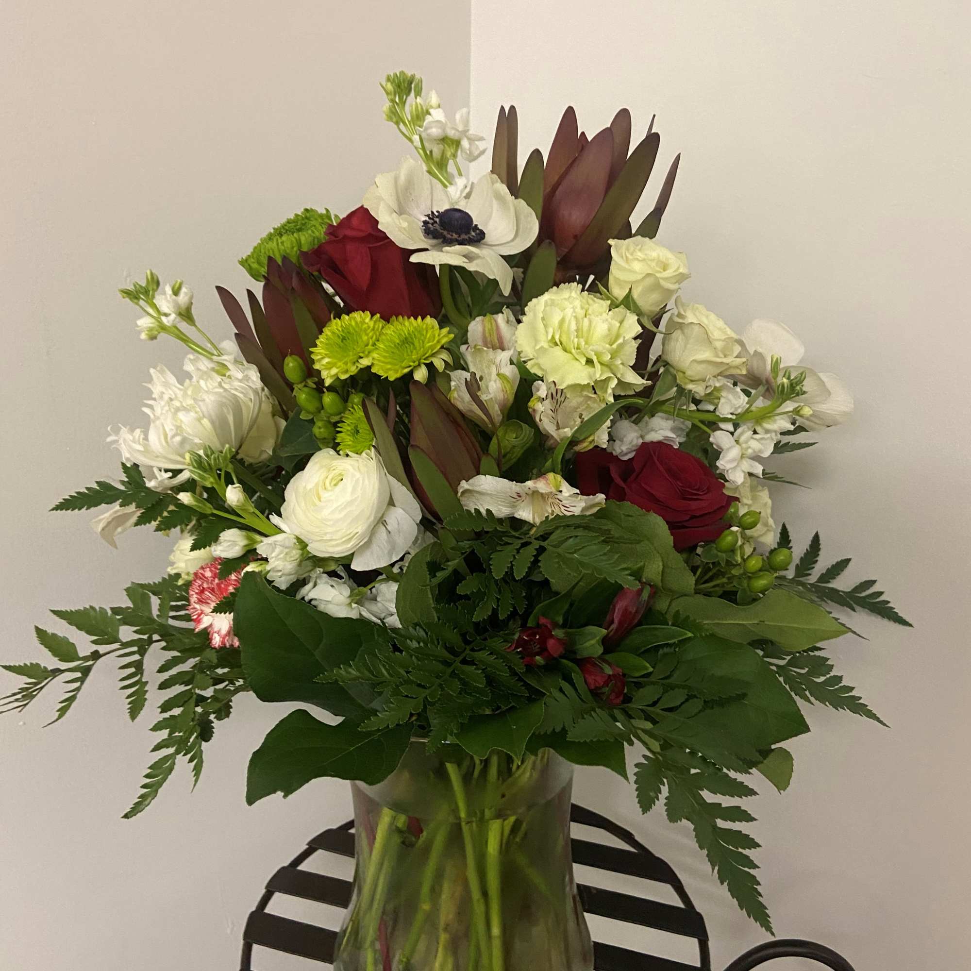 Mixed bouquet of red and white flowers in a glass vase