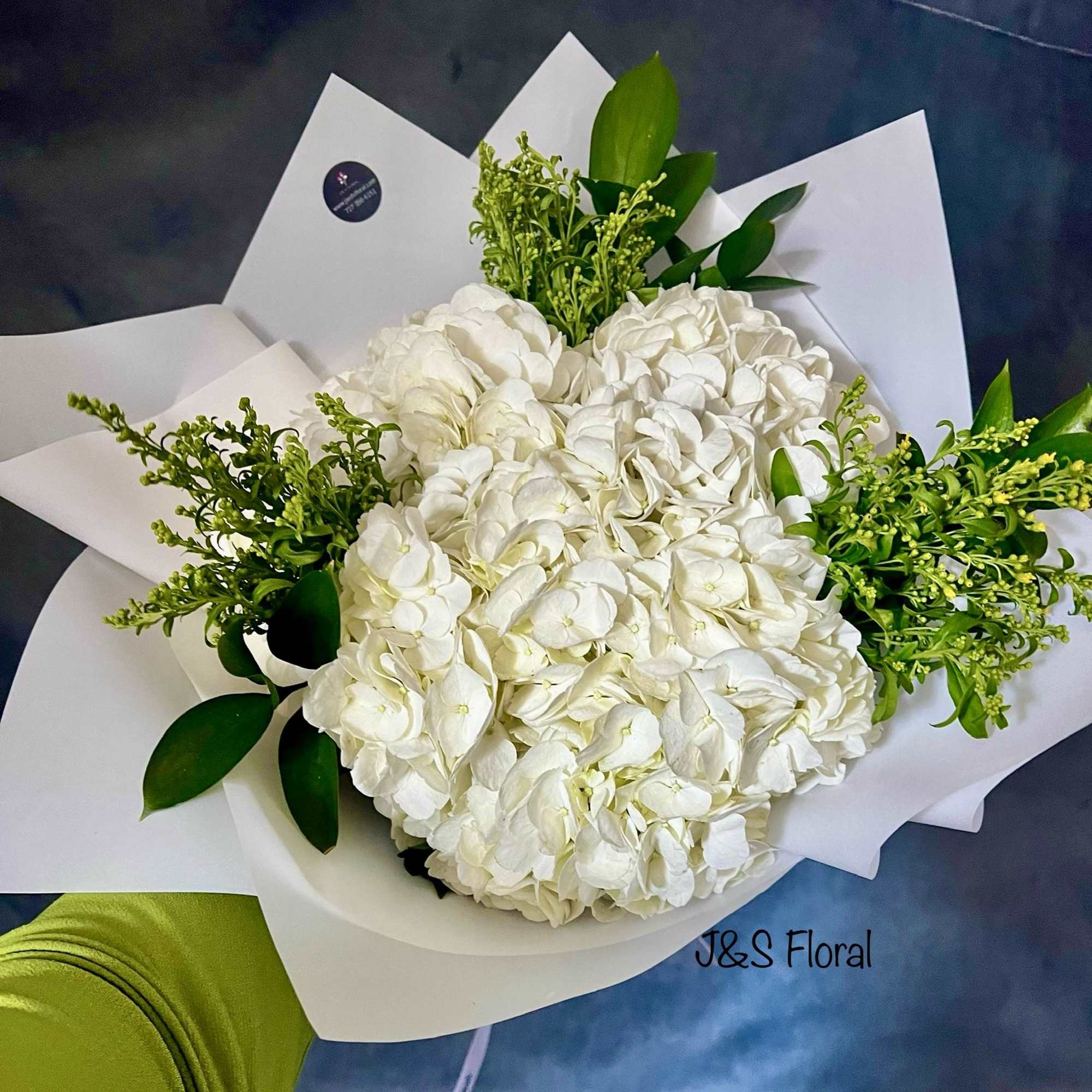 White hydrangea bouquet with green filler and white wrapping
