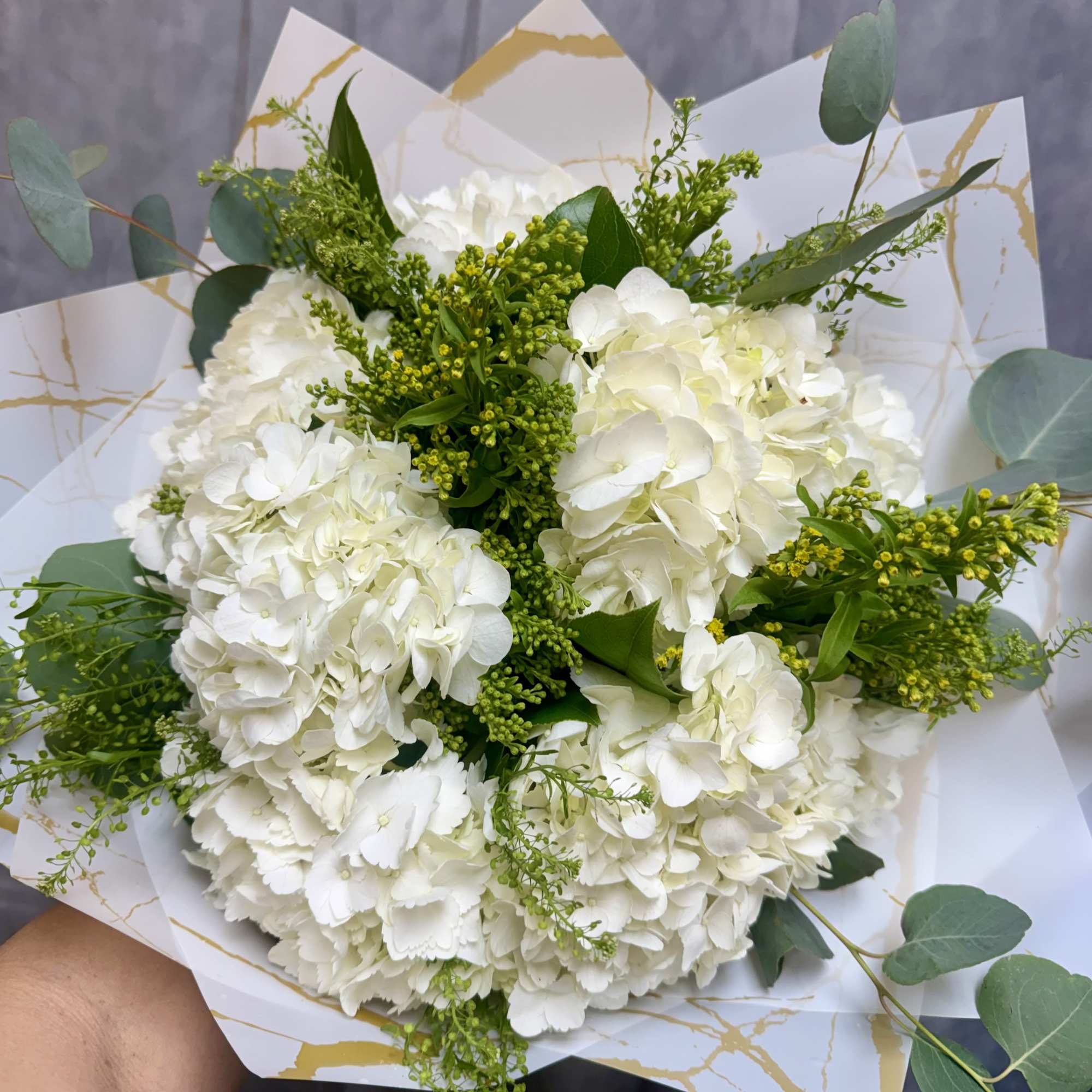 Introducing our new design White Hydrangeas bouquet, beautifully arranged with hydrangeas, baby's