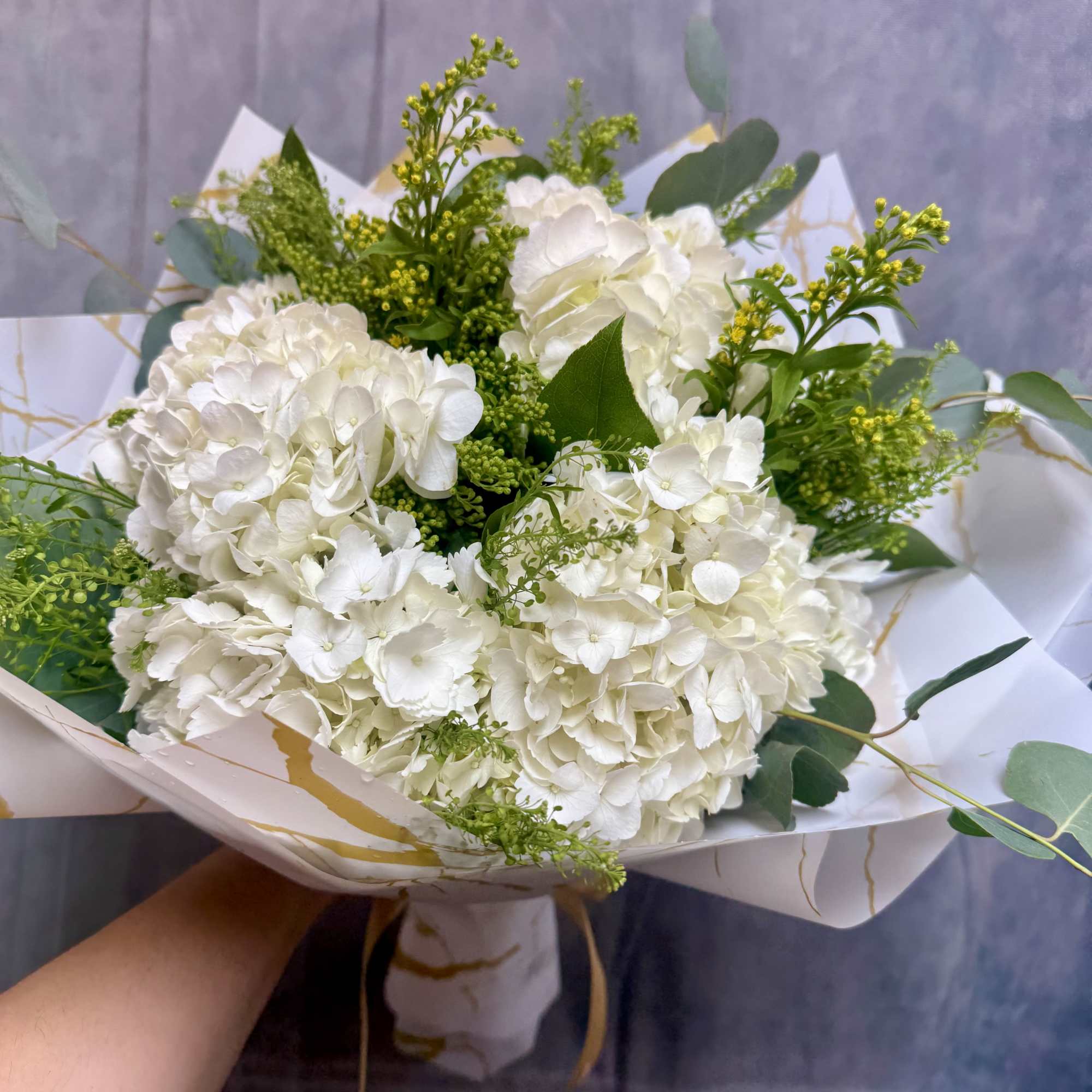 Introducing our new design White Hydrangeas bouquet, beautifully arranged with hydrangeas, baby's