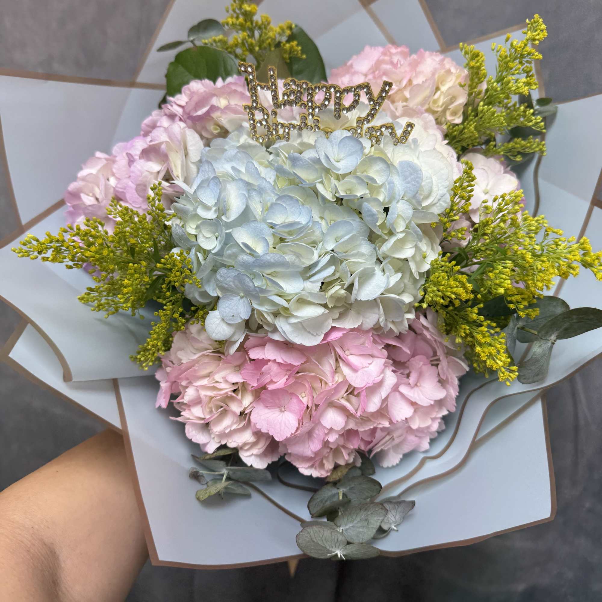 Pink and white hydrangea bouquet with a gold Happy Birthday topper