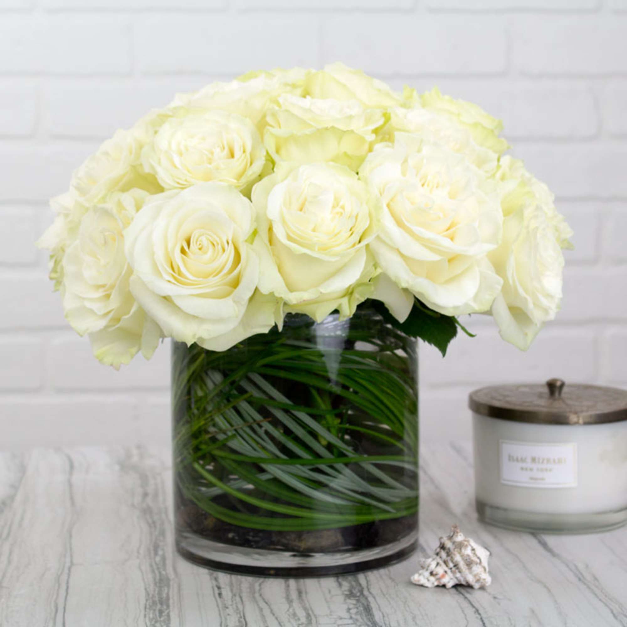 White roses arranged in a clear glass vase