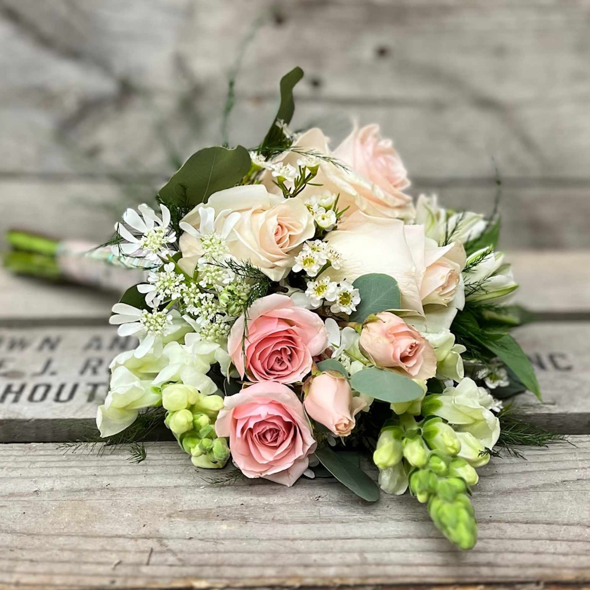 Bouquet of pink and white roses with small white filler flowers