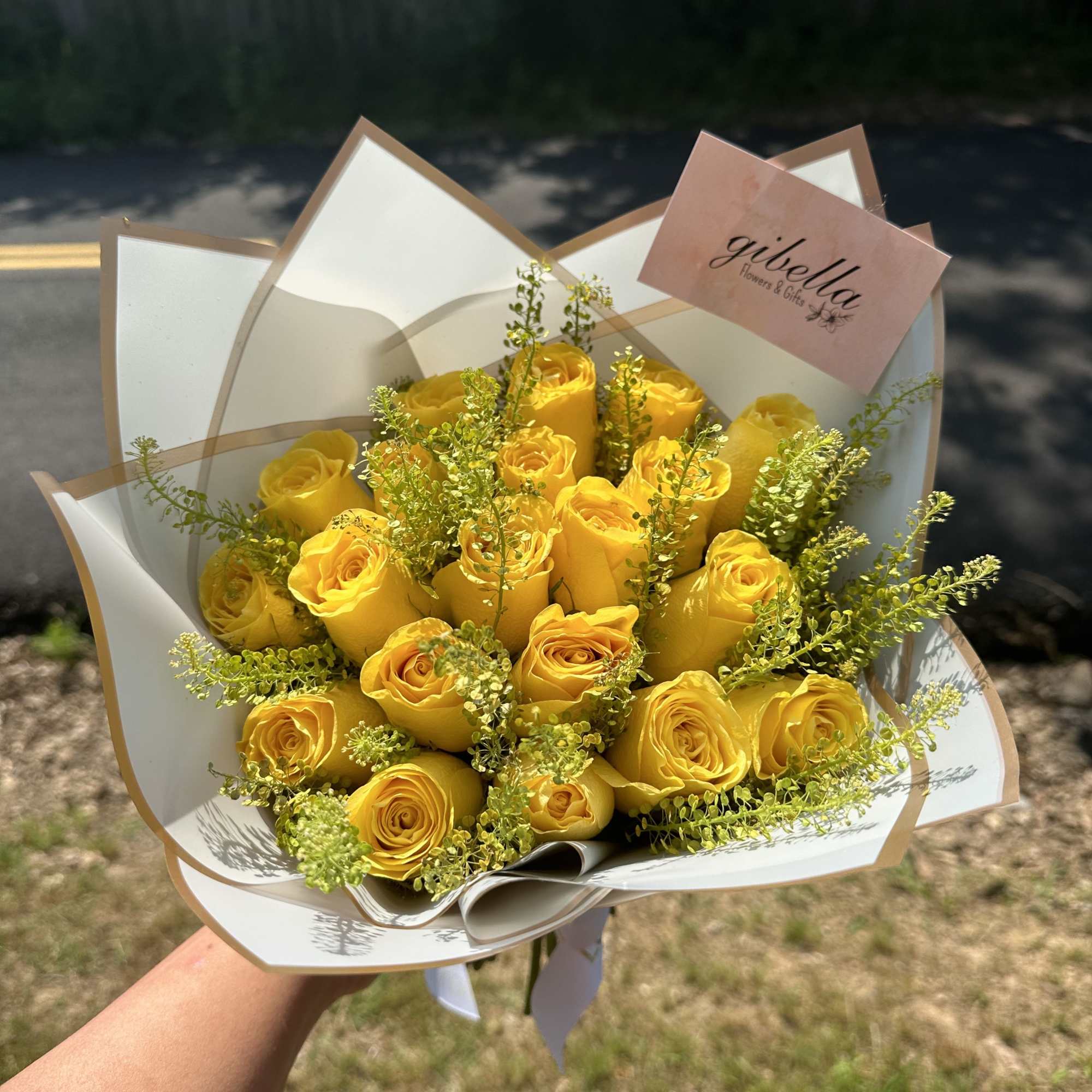 Bouquet of yellow roses wrapped in white paper