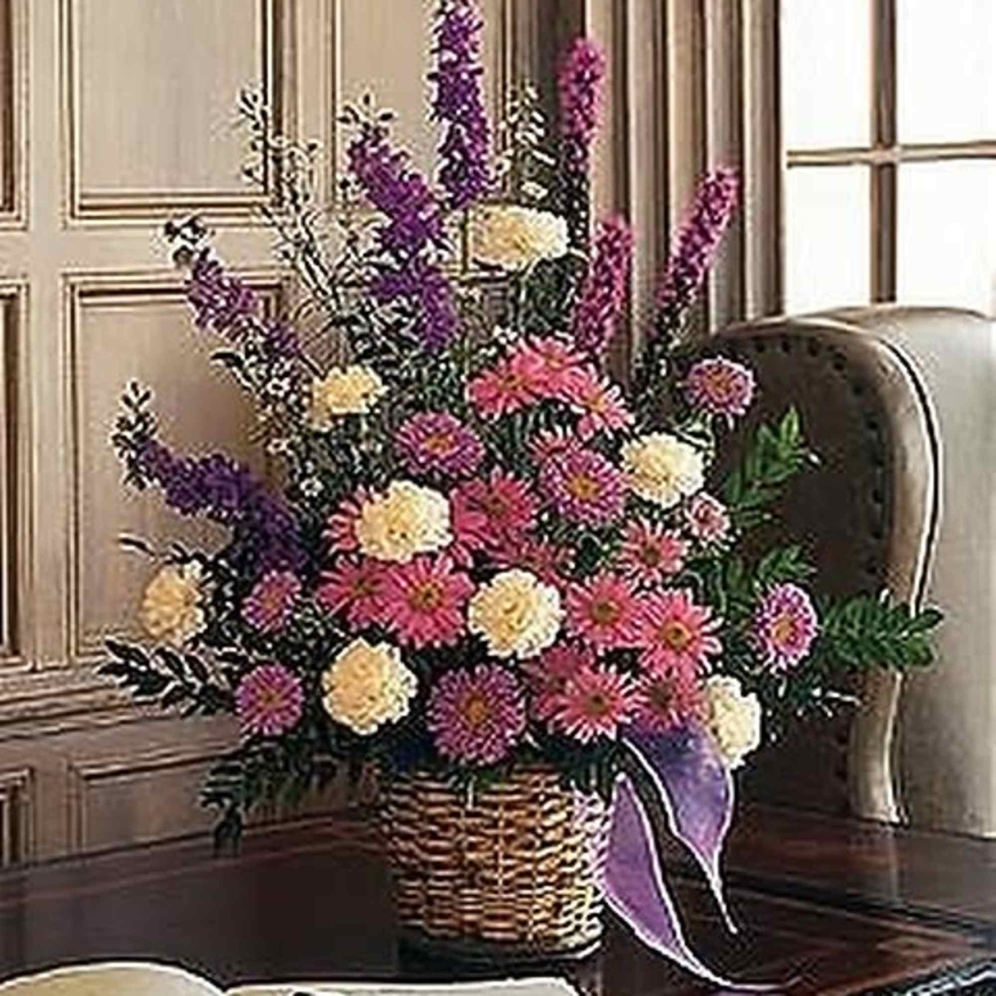 This lovely lavender arrangement, with its asters, chrysanthemums and larkspur, will remind