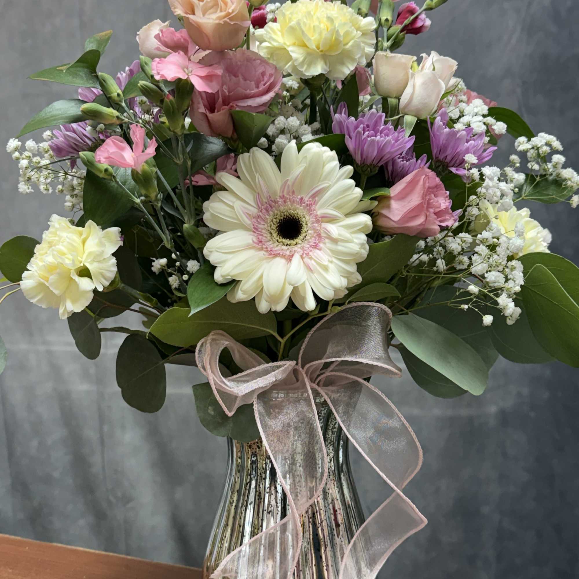 Soft pastel mix of gerbera, roses, carnations and blooms beautifully arranged in