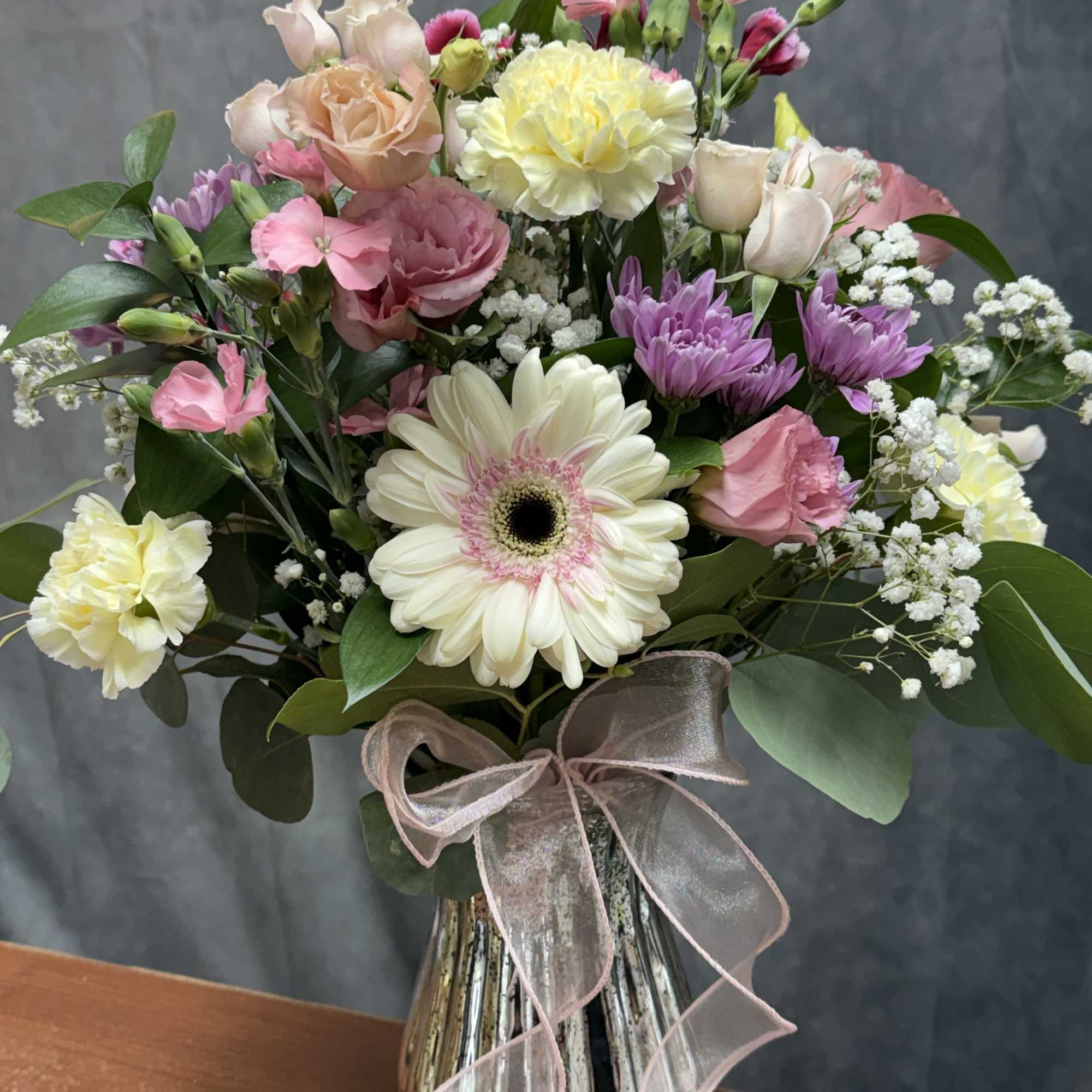 Soft pastel mix of gerbera, roses, carnations and blooms beautifully arranged in