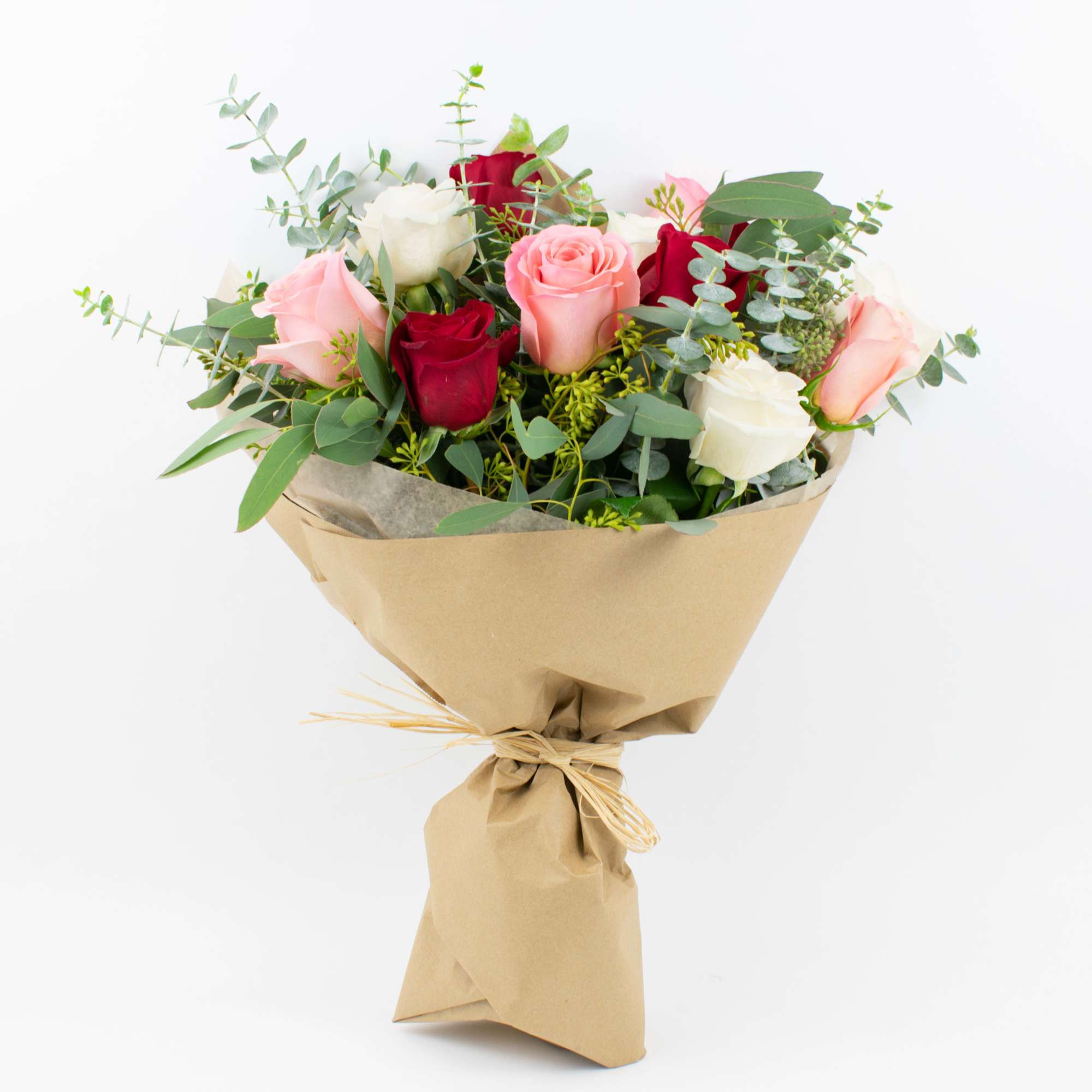 Bouquet of pink, red, and white roses wrapped in brown paper