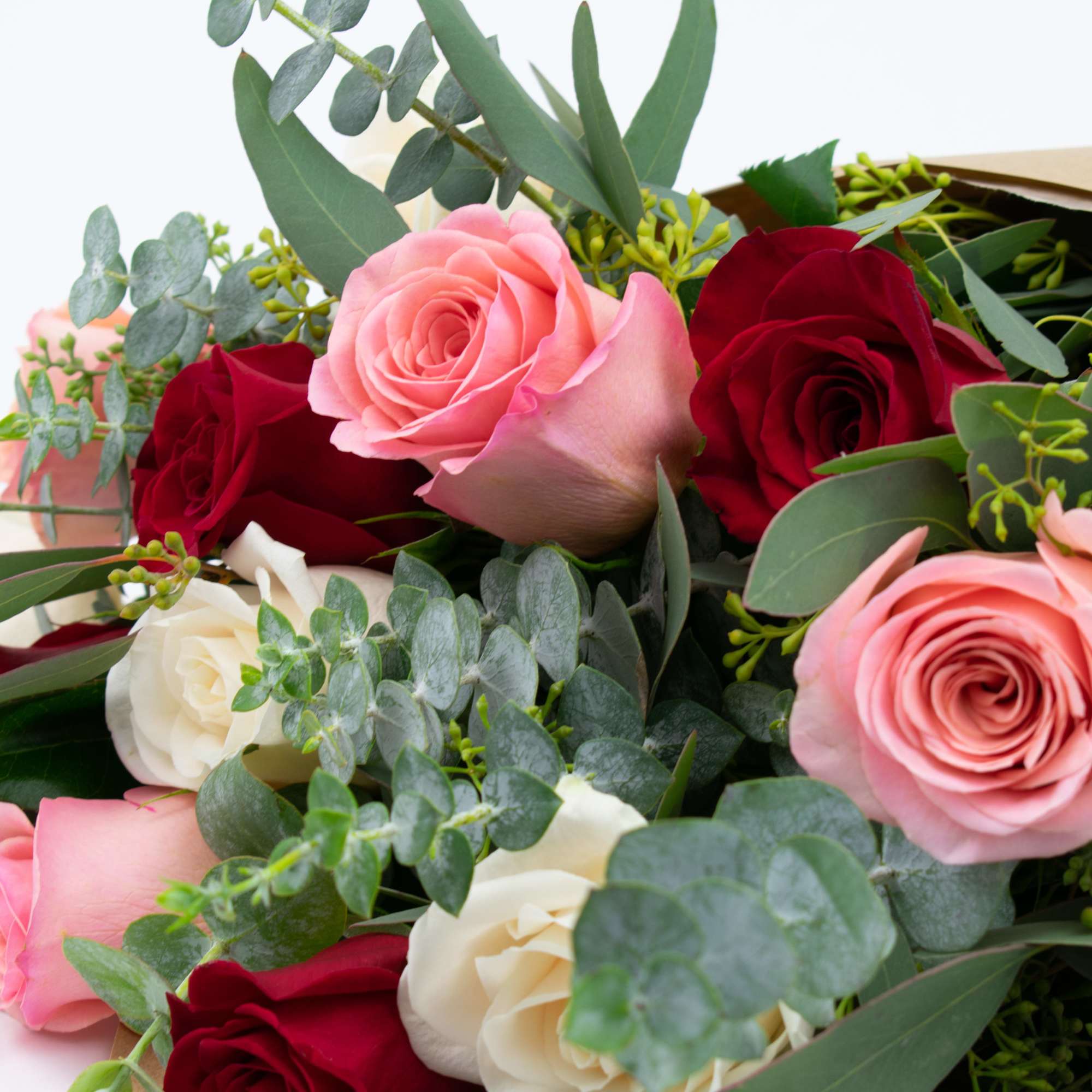Bouquet of pink, red, and white roses with eucalyptus