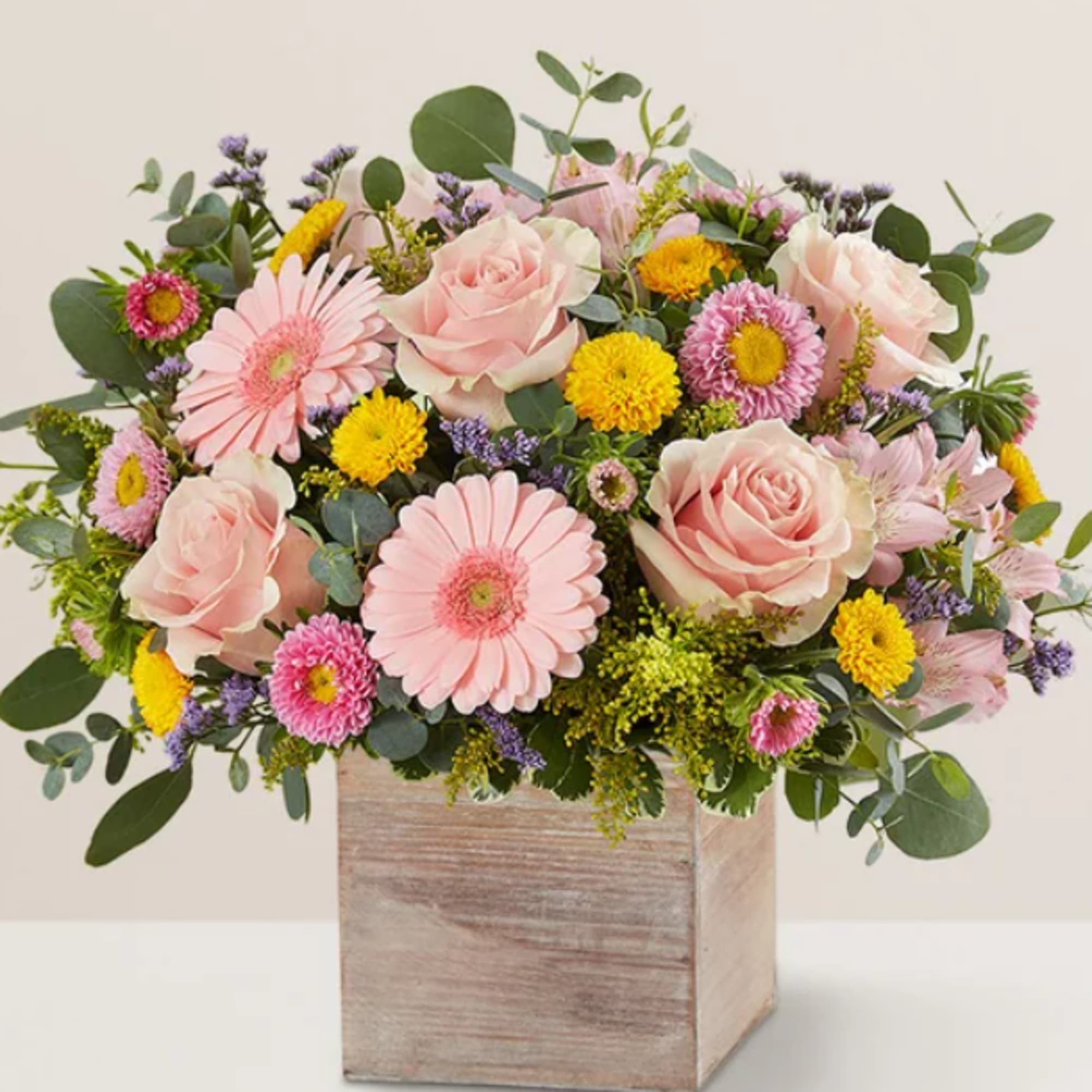 Pink roses and daisies in a wooden box arrangement
