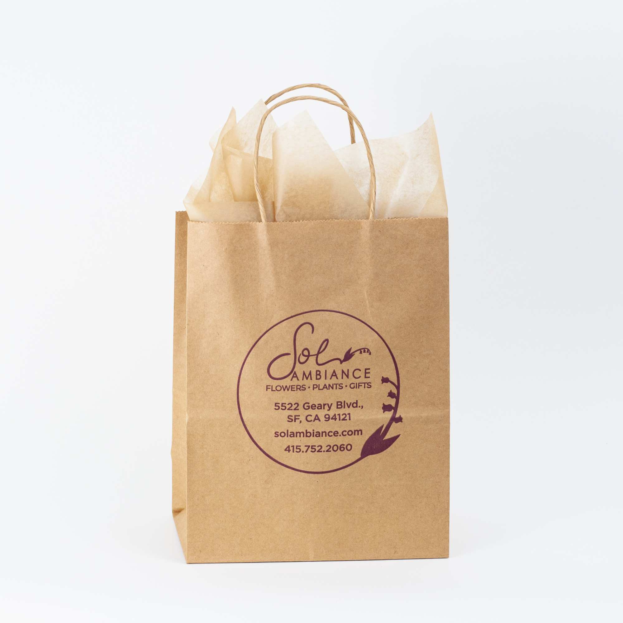 Brown paper gift bag with tissue paper and a florist logo